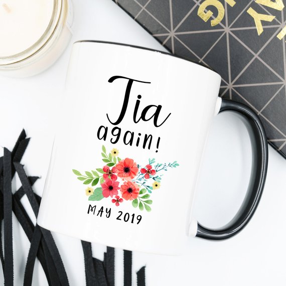 Tia Cup Pregnancy Announcement Cup in white ceramic with vibrant design, showcasing both front and back prints.