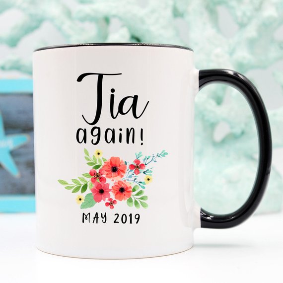 Tia Cup Pregnancy Announcement Cup in white ceramic with vibrant design, showcasing both front and back prints.