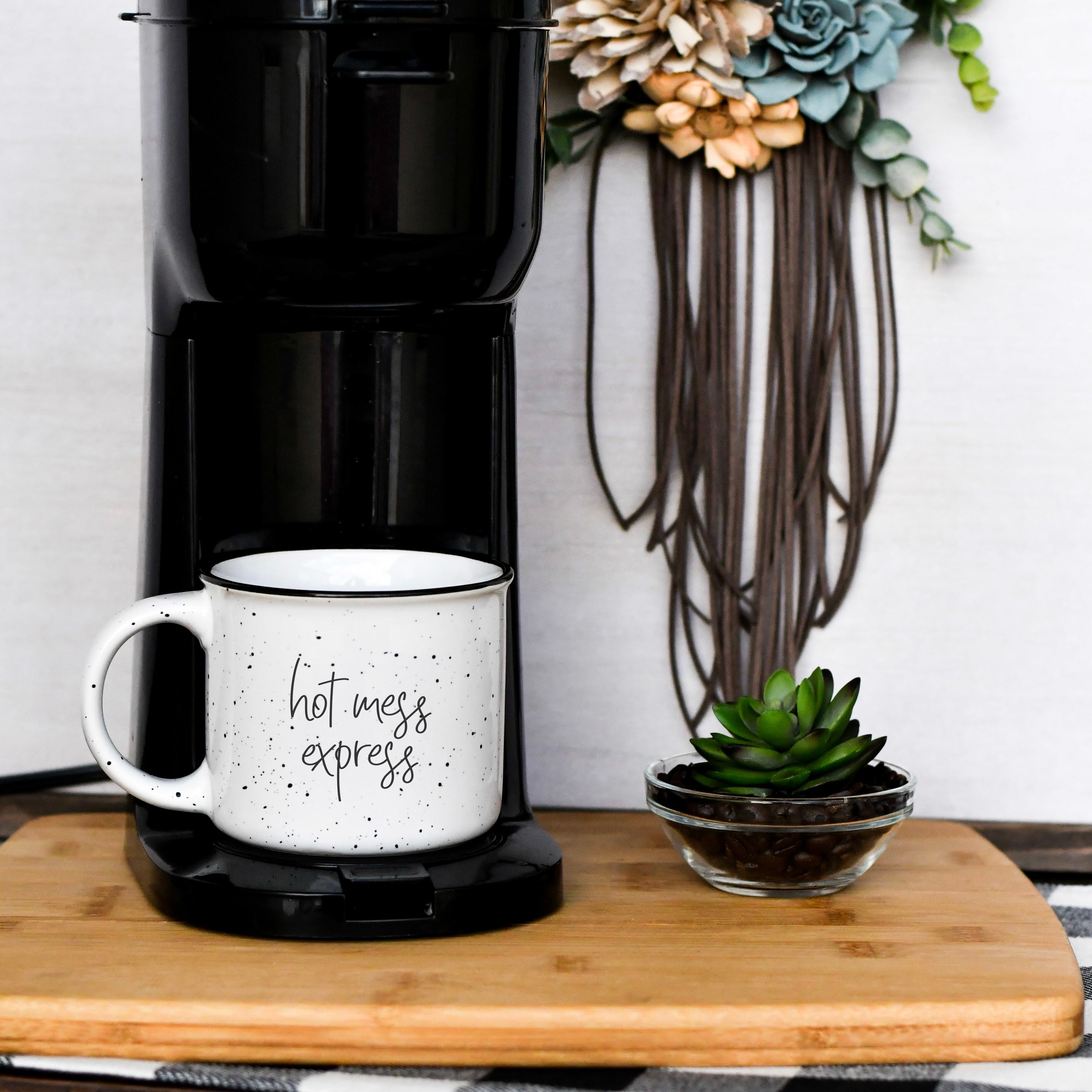 Tired as a Mother Campfire Mug with black rim and double-sided design, featuring white sesame glaze and bold black lettering.