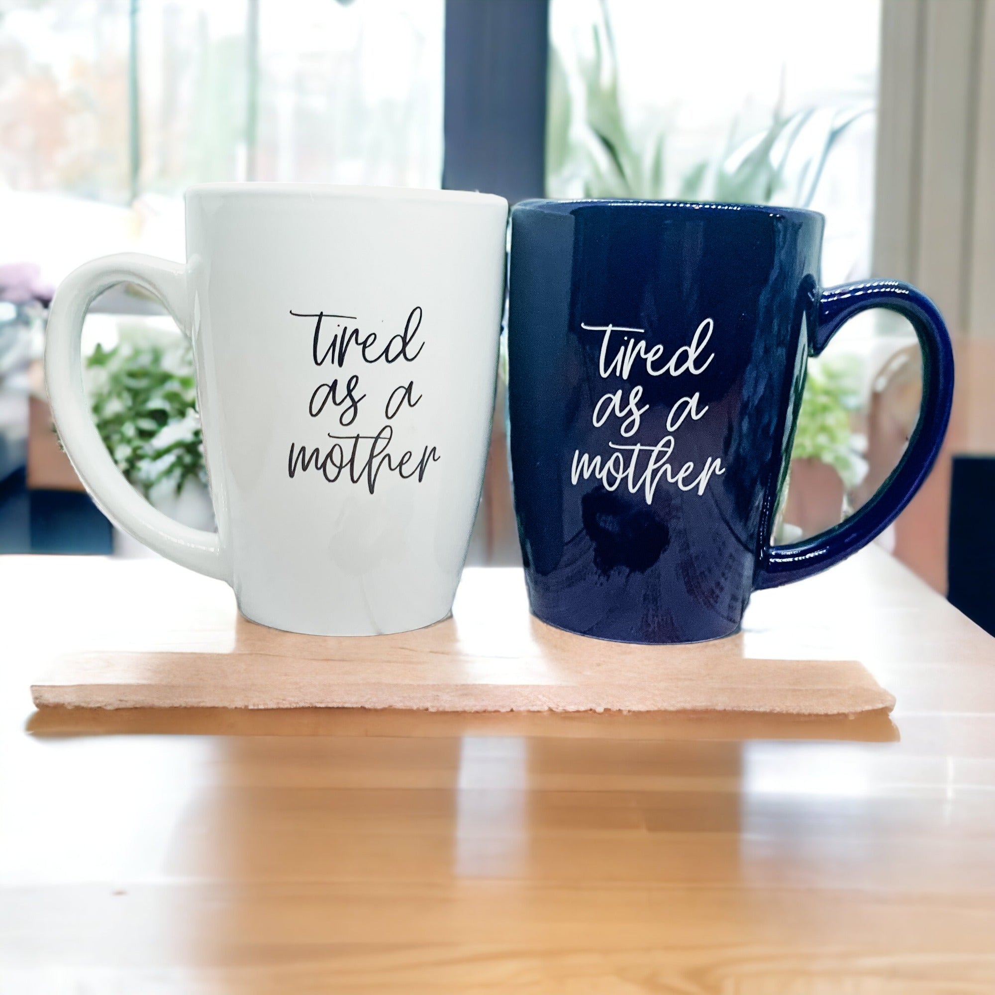 Tired as a Mother Grande mug in navy blue and white, featuring double-sided design with humorous text, perfect for mothers.