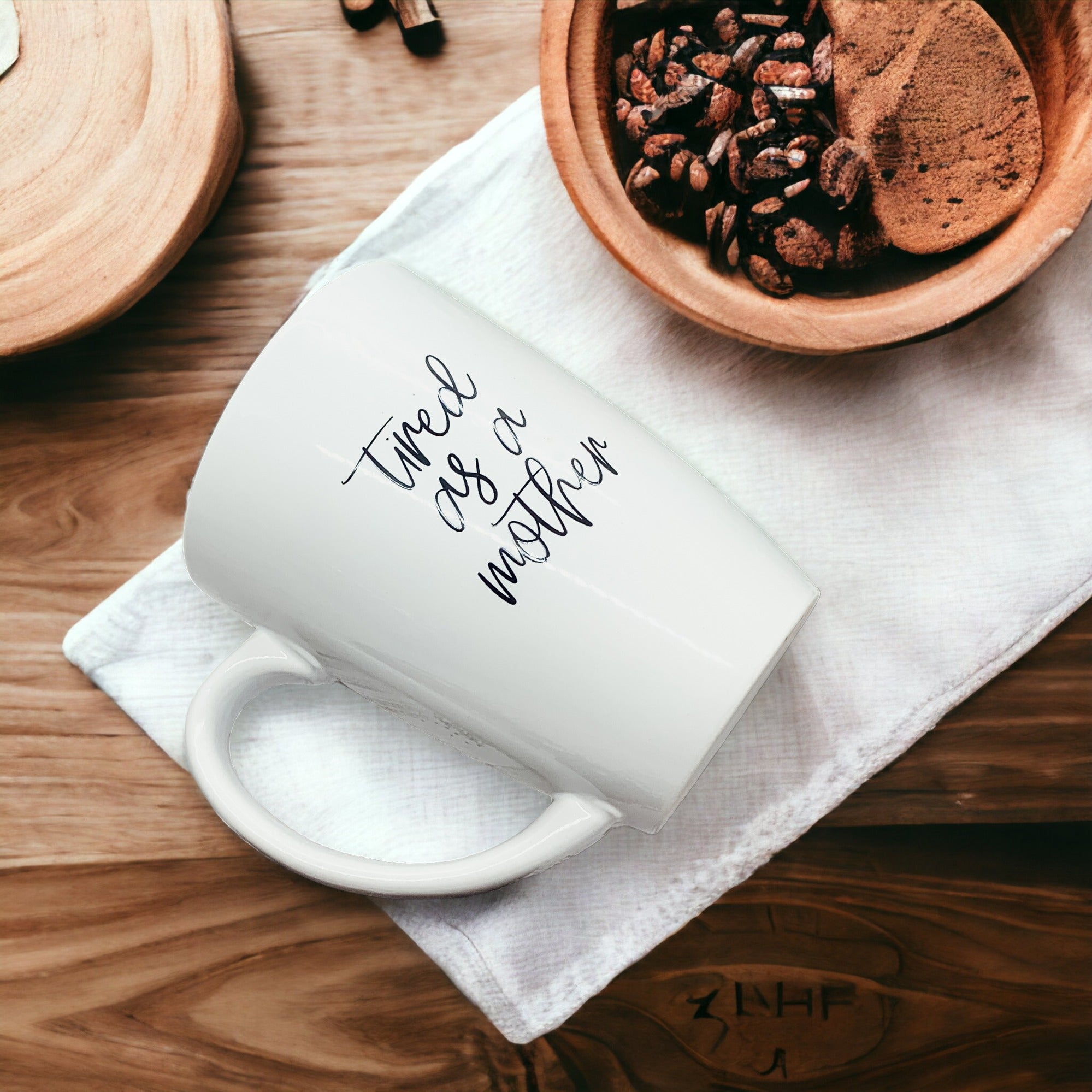 Tired as a Mother Grande mug in navy blue and white, featuring double-sided design with humorous text, perfect for mothers.