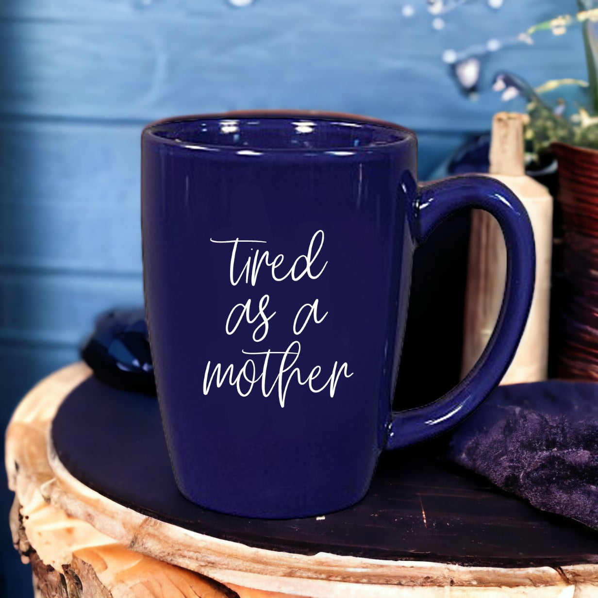 Tired as a Mother Grande mug in navy blue and white, featuring double-sided design with humorous text, perfect for mothers.