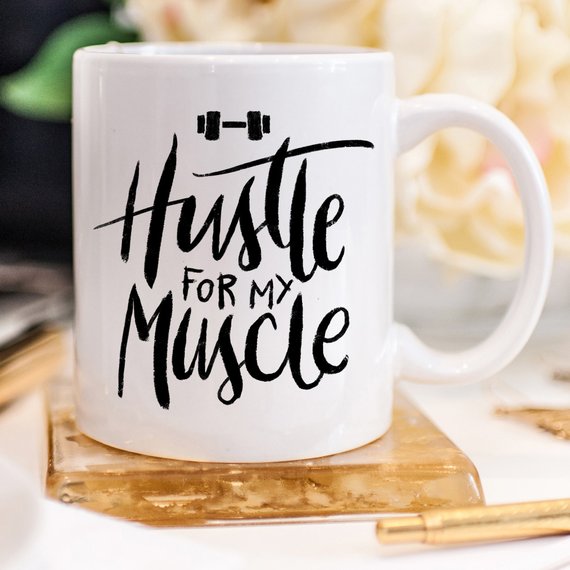 Hustle For The Muscle funny coffee mug featuring a humorous fitness design, perfect for coffee lovers and gym enthusiasts.