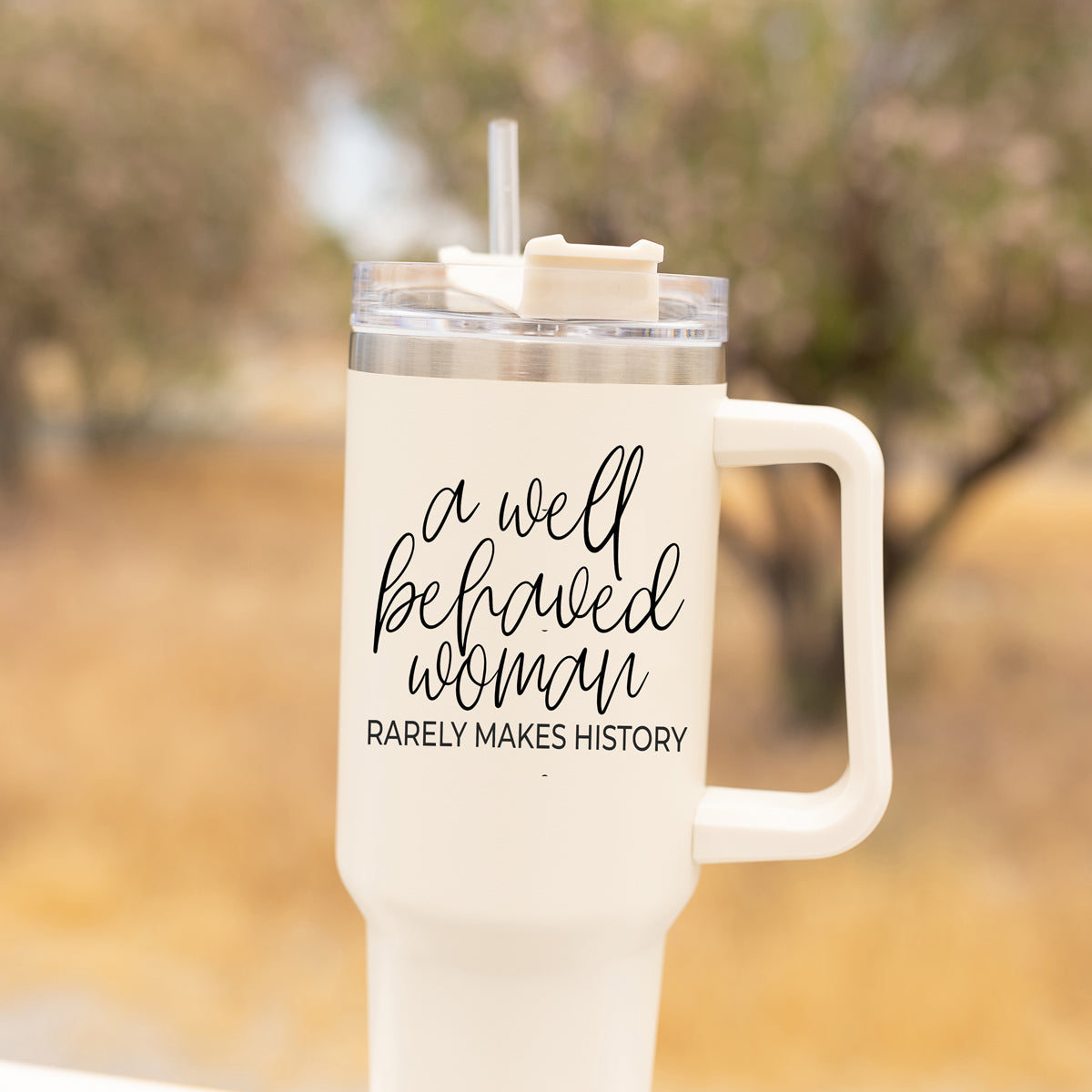 Well Behaved Woman 40oz insulated mug with a matte cream finish, featuring a black graphic design and a versatile 3-in-1 lid.