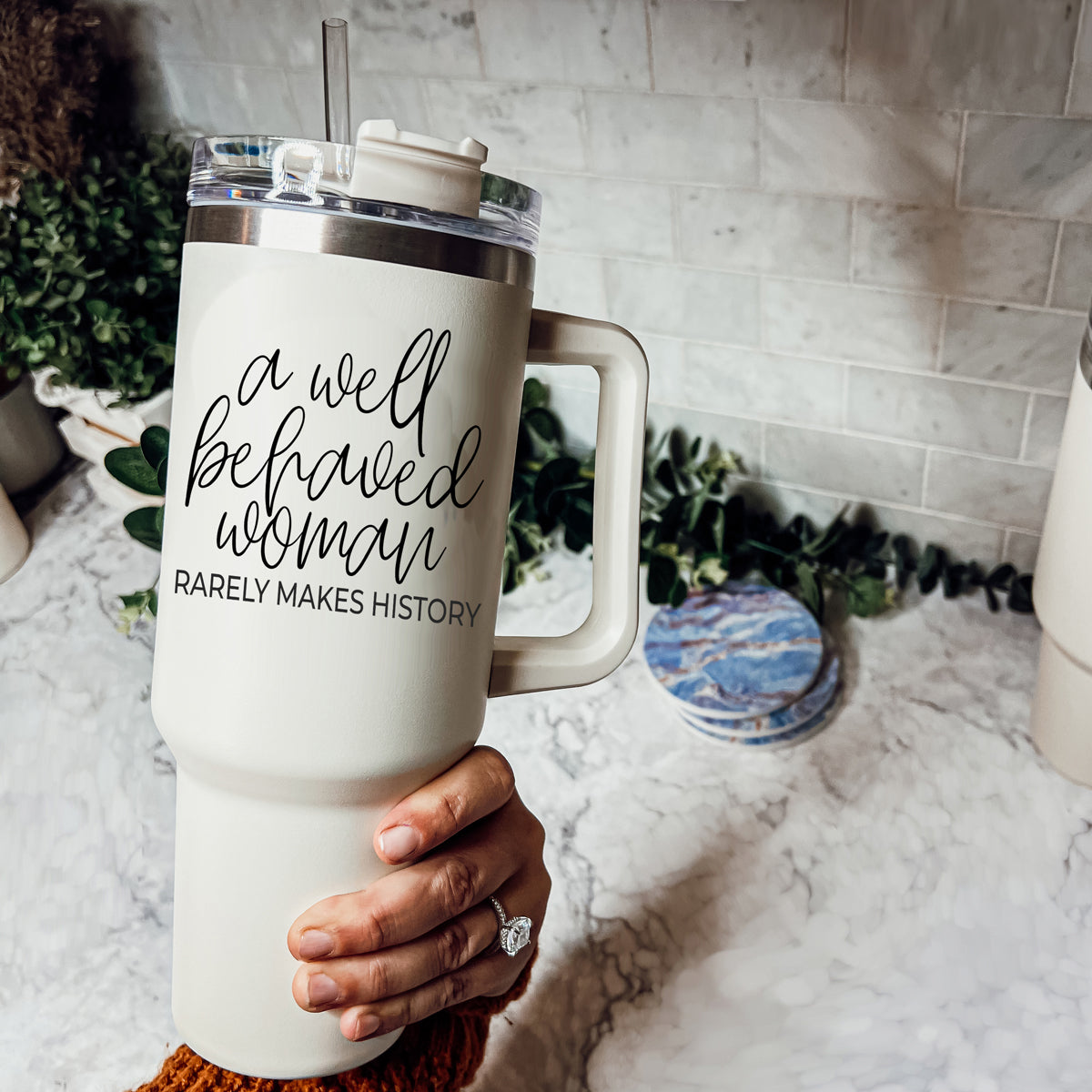 Well Behaved Woman 40oz insulated mug with a matte cream finish, featuring a black graphic design and a versatile 3-in-1 lid.