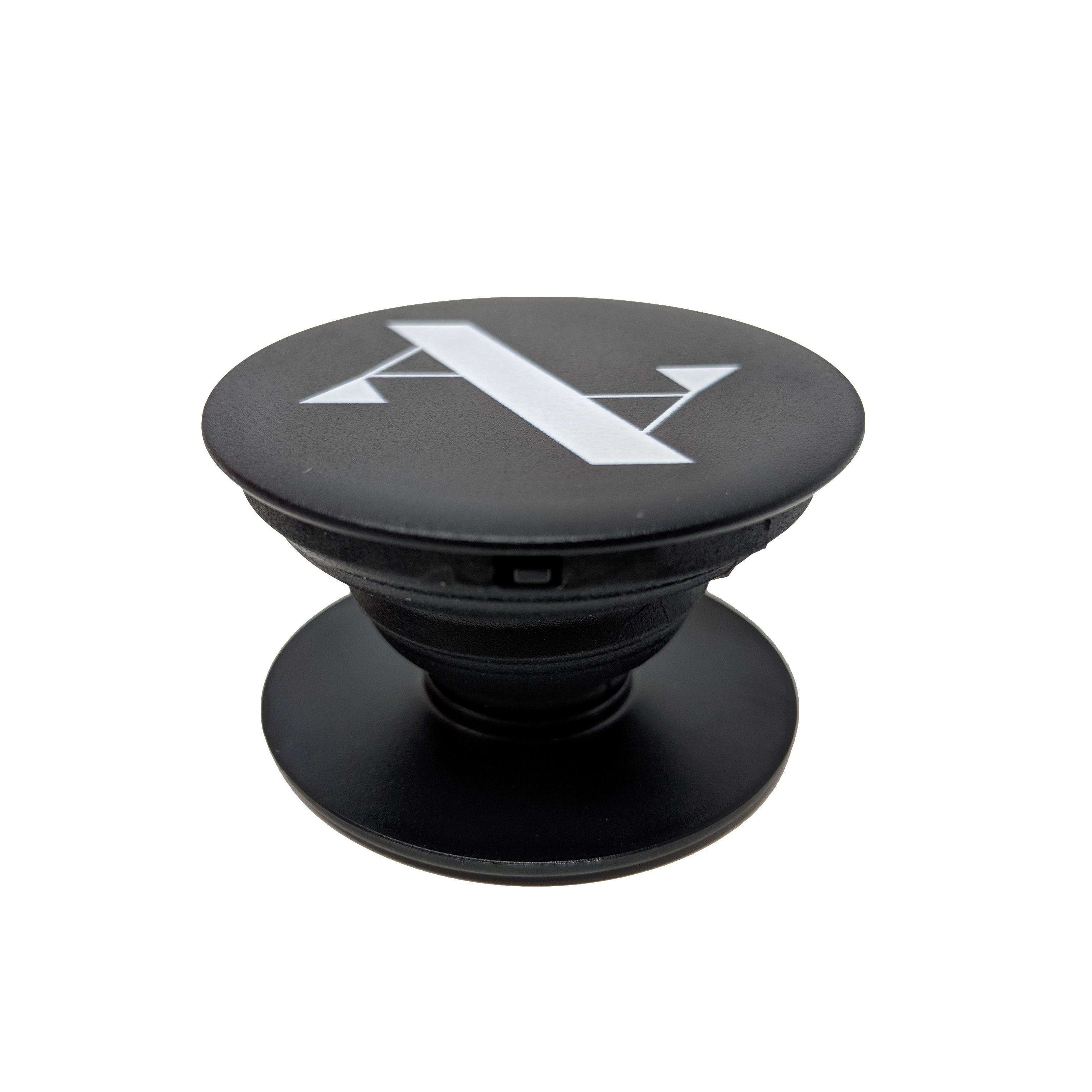 Black MAAD Grip accessory for smartphones and tablets, enhancing grip and serving as a stand.