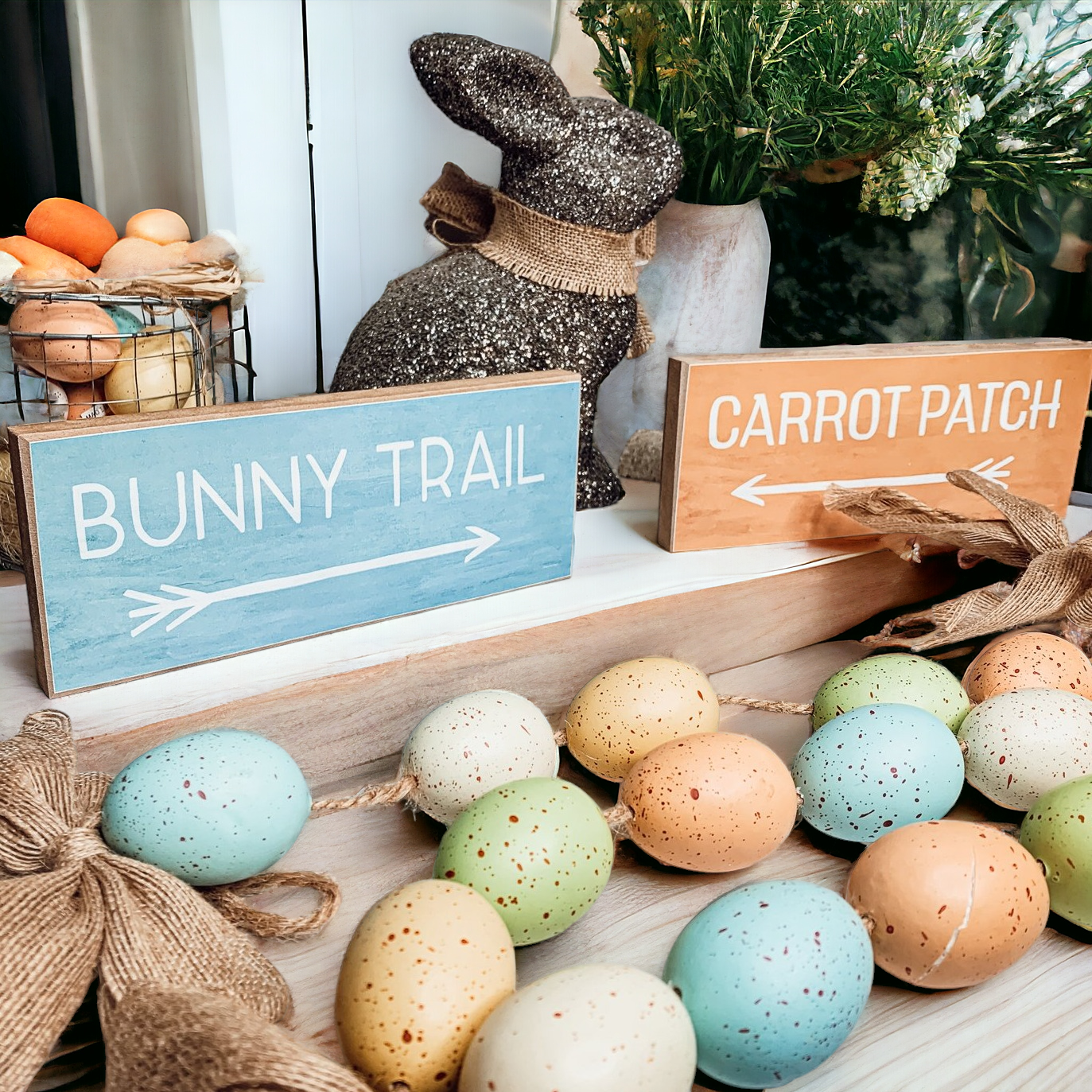 Two wooden block signs featuring Bunny Trail and Carrot Patch designs in pastel colors, perfect for Easter decor.