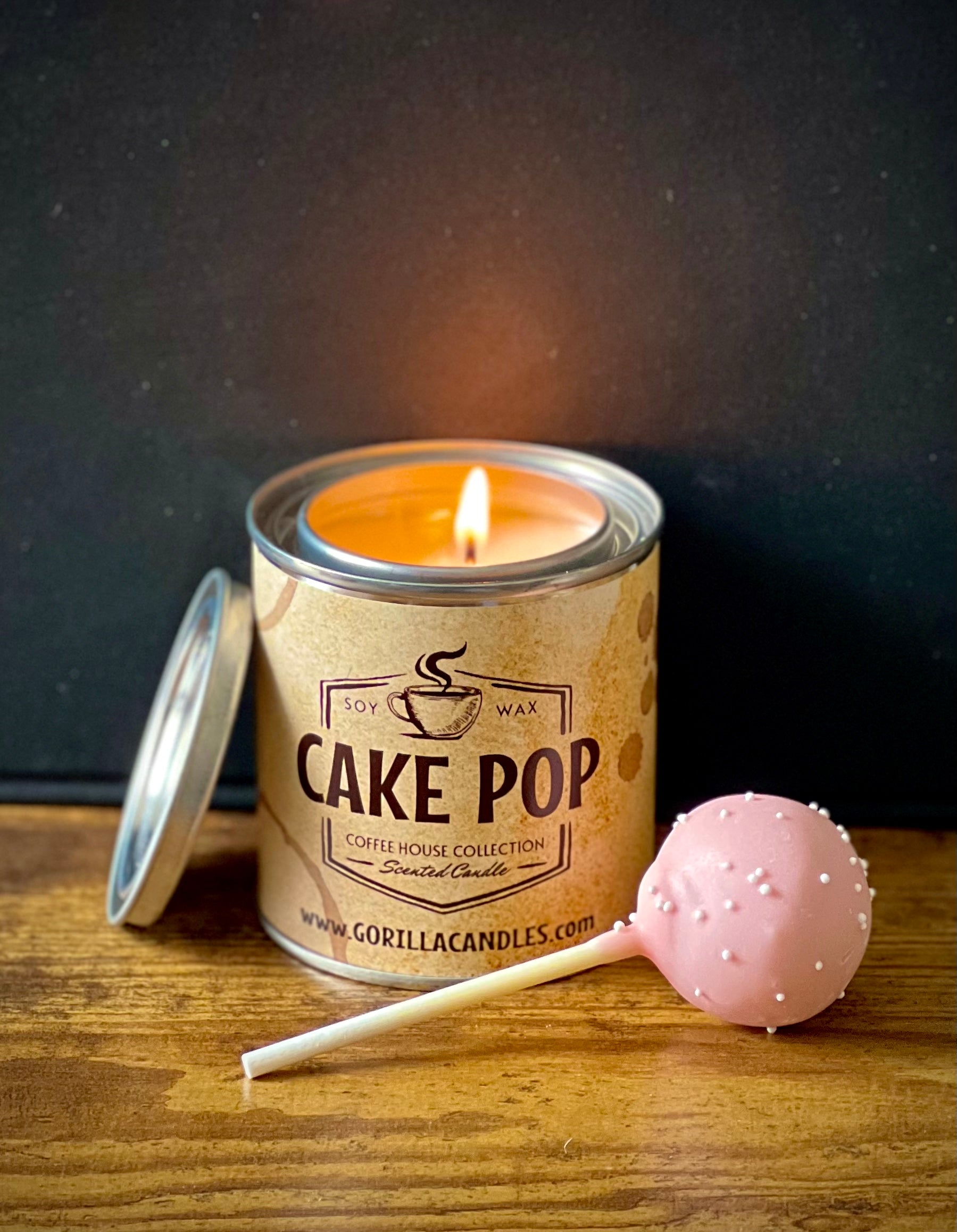 A charming 8-ounce Cake Pop Scented Candle in a 1/2 pint paint can, showcasing its delightful design and eco-friendly soy wax.