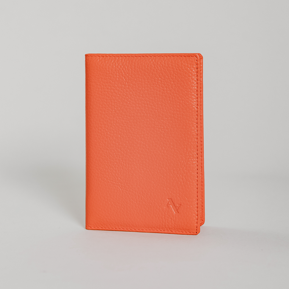 Coral Pebble Passport Holder made from durable leather with monogram personalization options and multiple card slots.