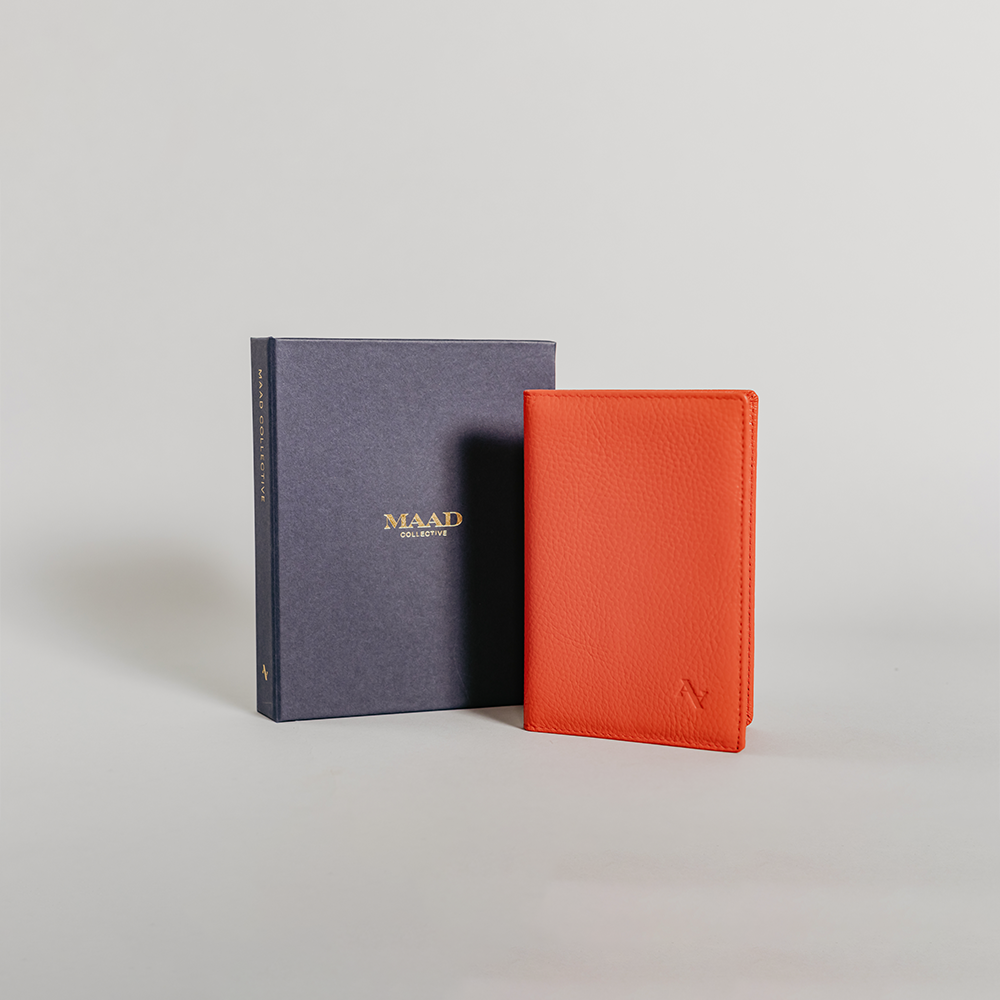 Coral Pebble Passport Holder made from durable leather with monogram personalization options and multiple card slots.