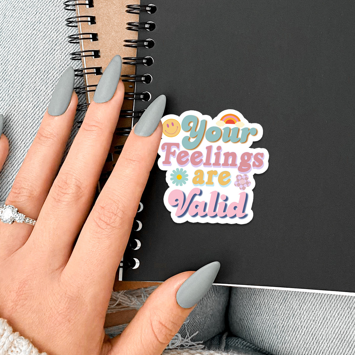 A collection of colorful 'Feelings are Valid' vinyl stickers showcasing unique designs, perfect for personalizing various items.