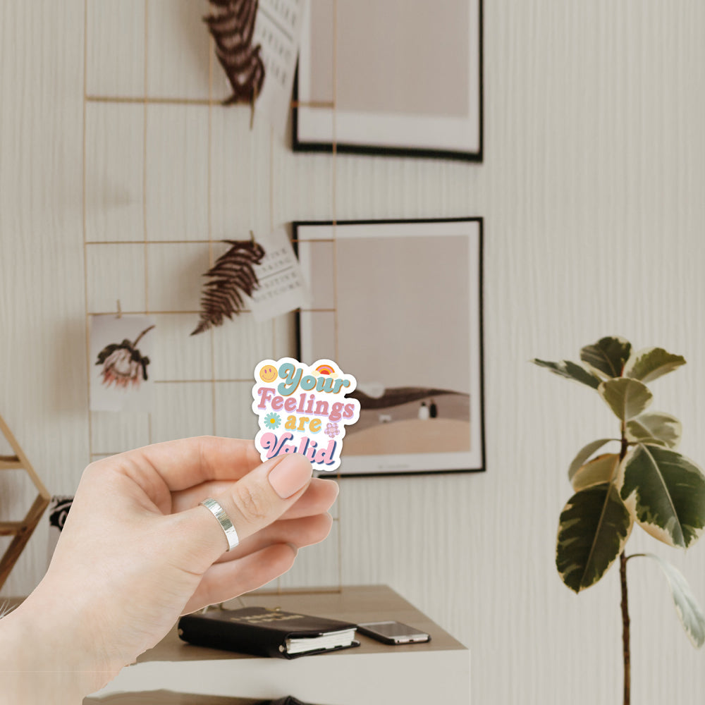 A collection of colorful 'Feelings are Valid' vinyl stickers showcasing unique designs, perfect for personalizing various items.