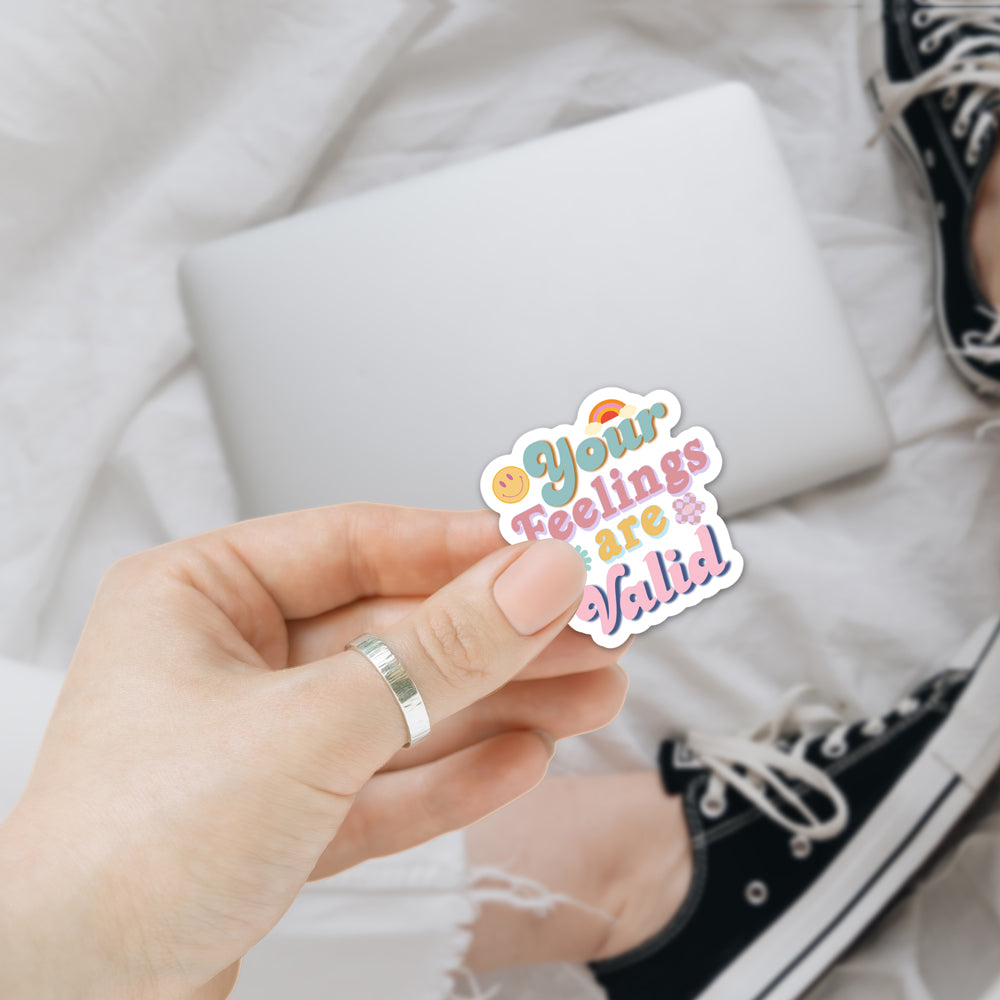 A collection of colorful 'Feelings are Valid' vinyl stickers showcasing unique designs, perfect for personalizing various items.