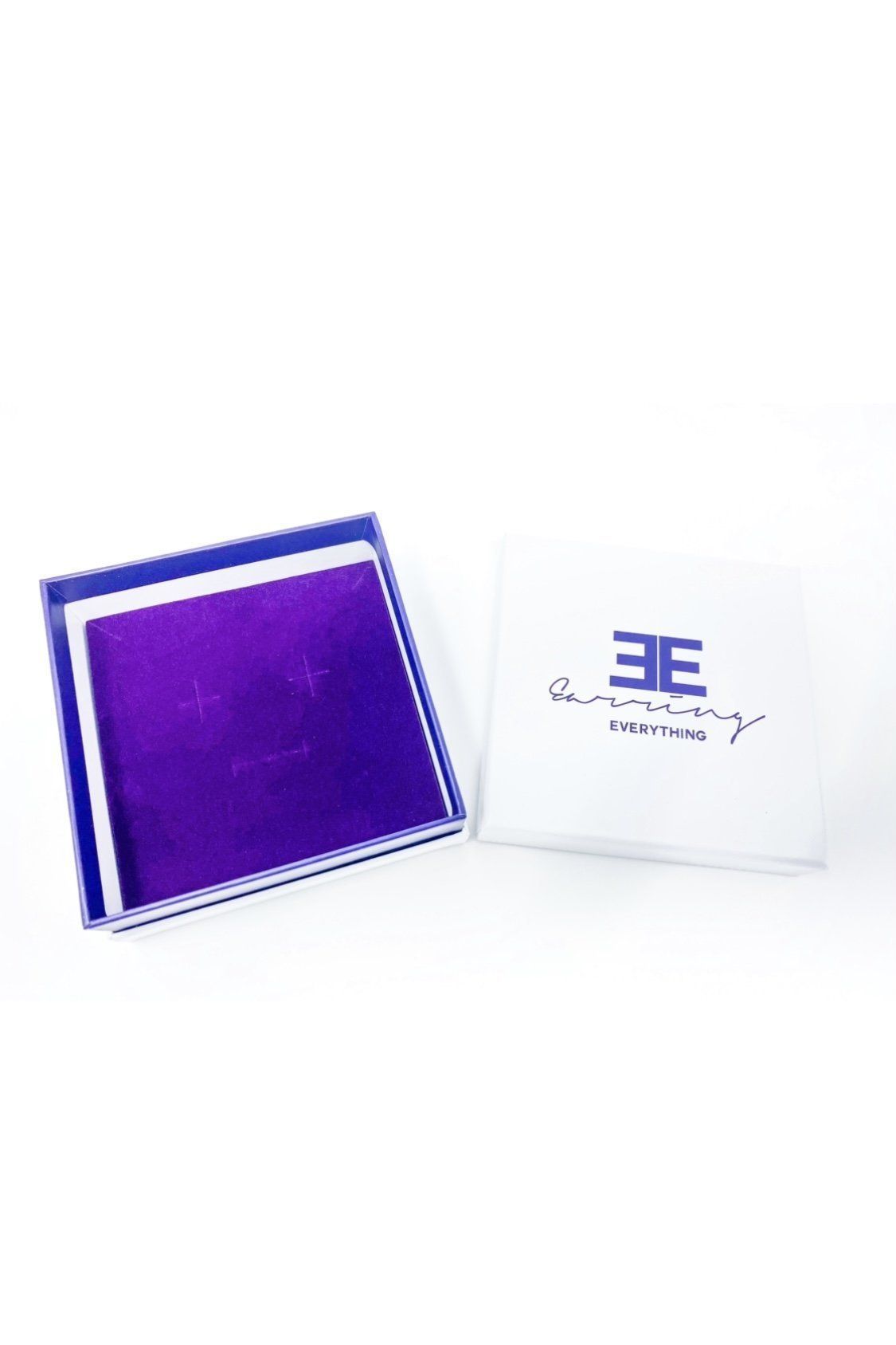 Elegant white monogrammed gift box with purple velvet inset, perfect for personalized gifting.