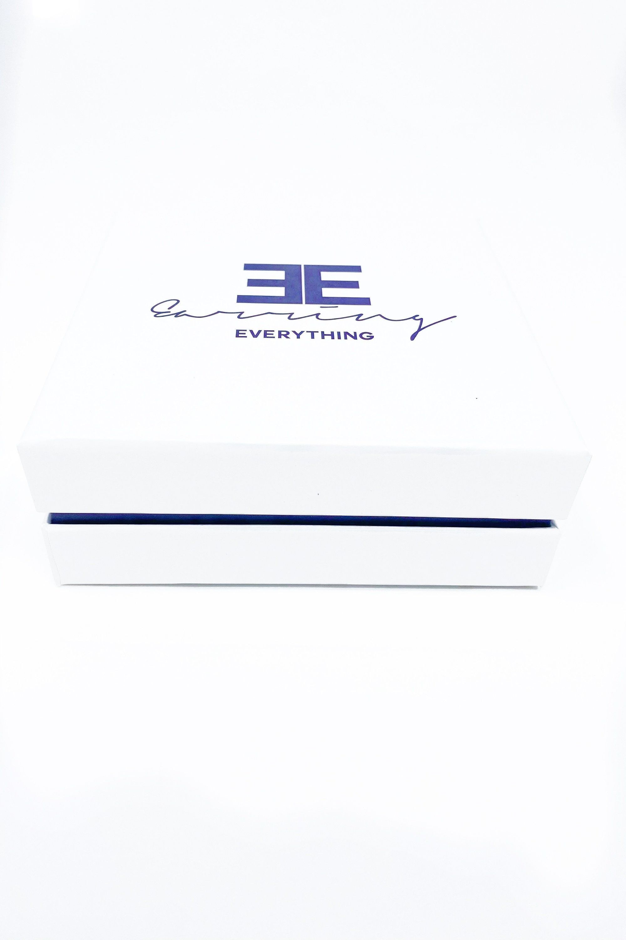 Elegant white monogrammed gift box with purple velvet inset, perfect for personalized gifting.