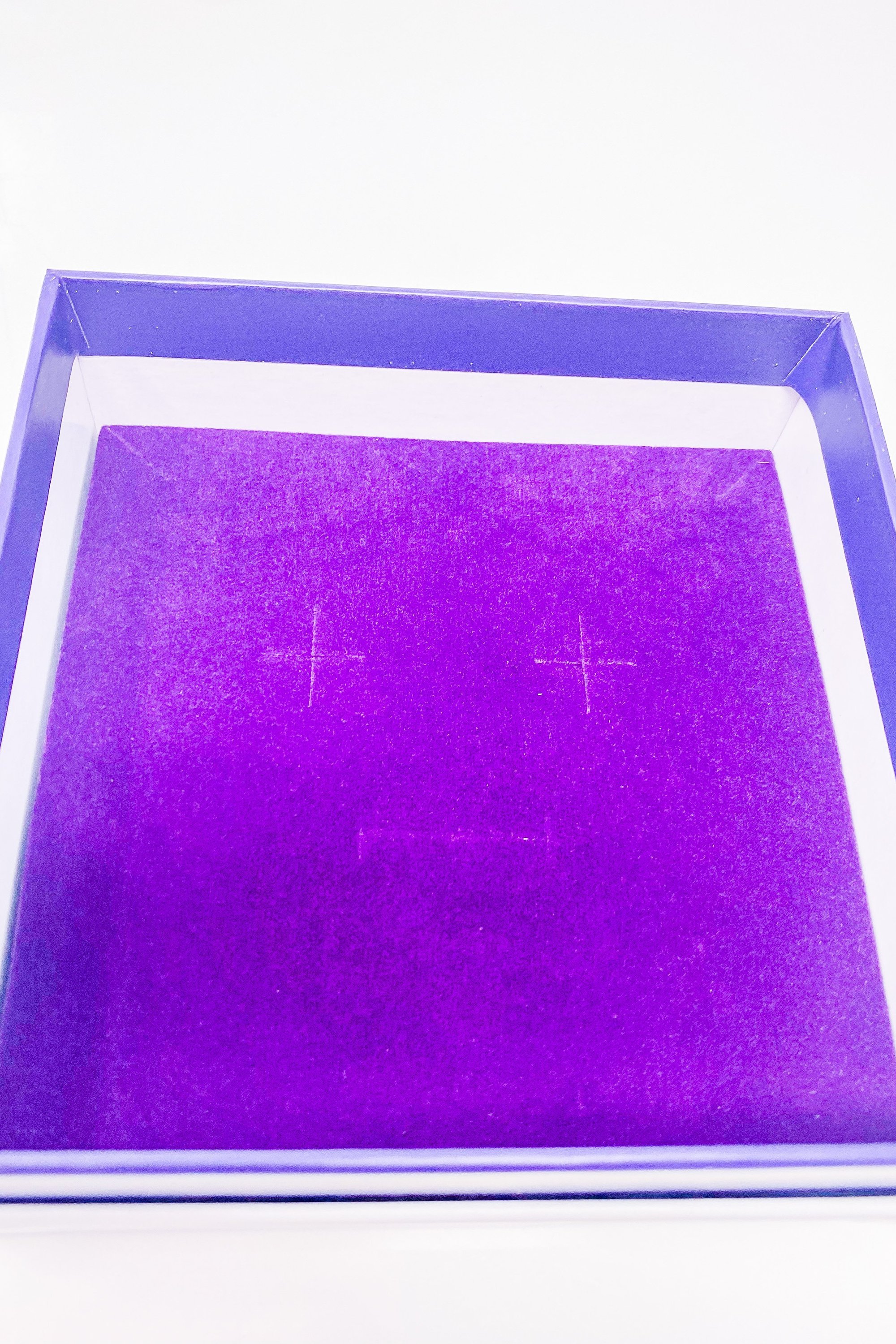 Elegant white monogrammed gift box with purple velvet inset, perfect for personalized gifting.