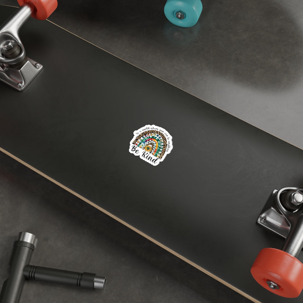 A collection of colorful die-cut stickers showcasing various custom designs on a smooth surface.