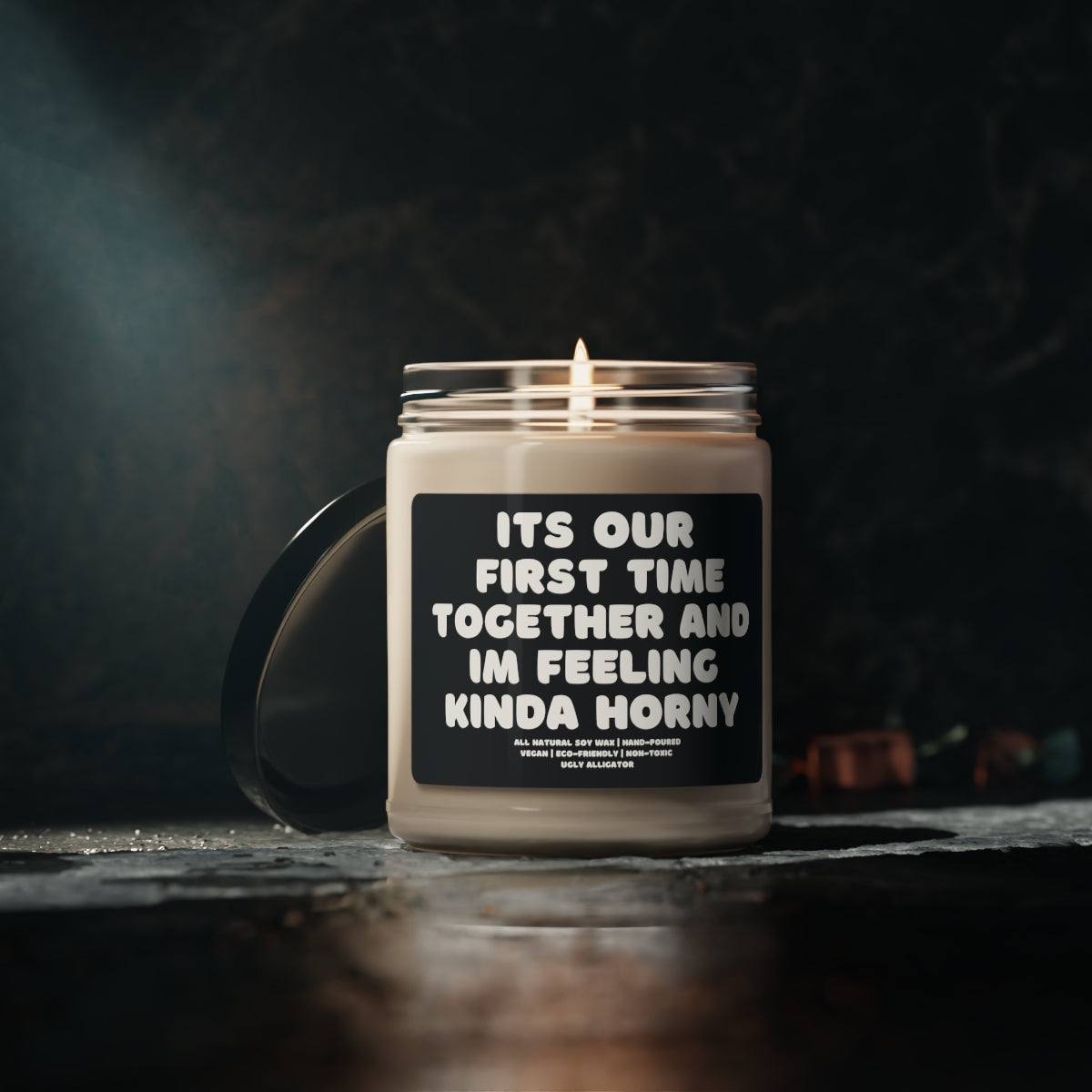 A stylish 9oz glass jar soy candle labeled 'It's Our First Time Together And I'm Feeling Kinda Horny', showcasing its elegant design and inviting aroma.