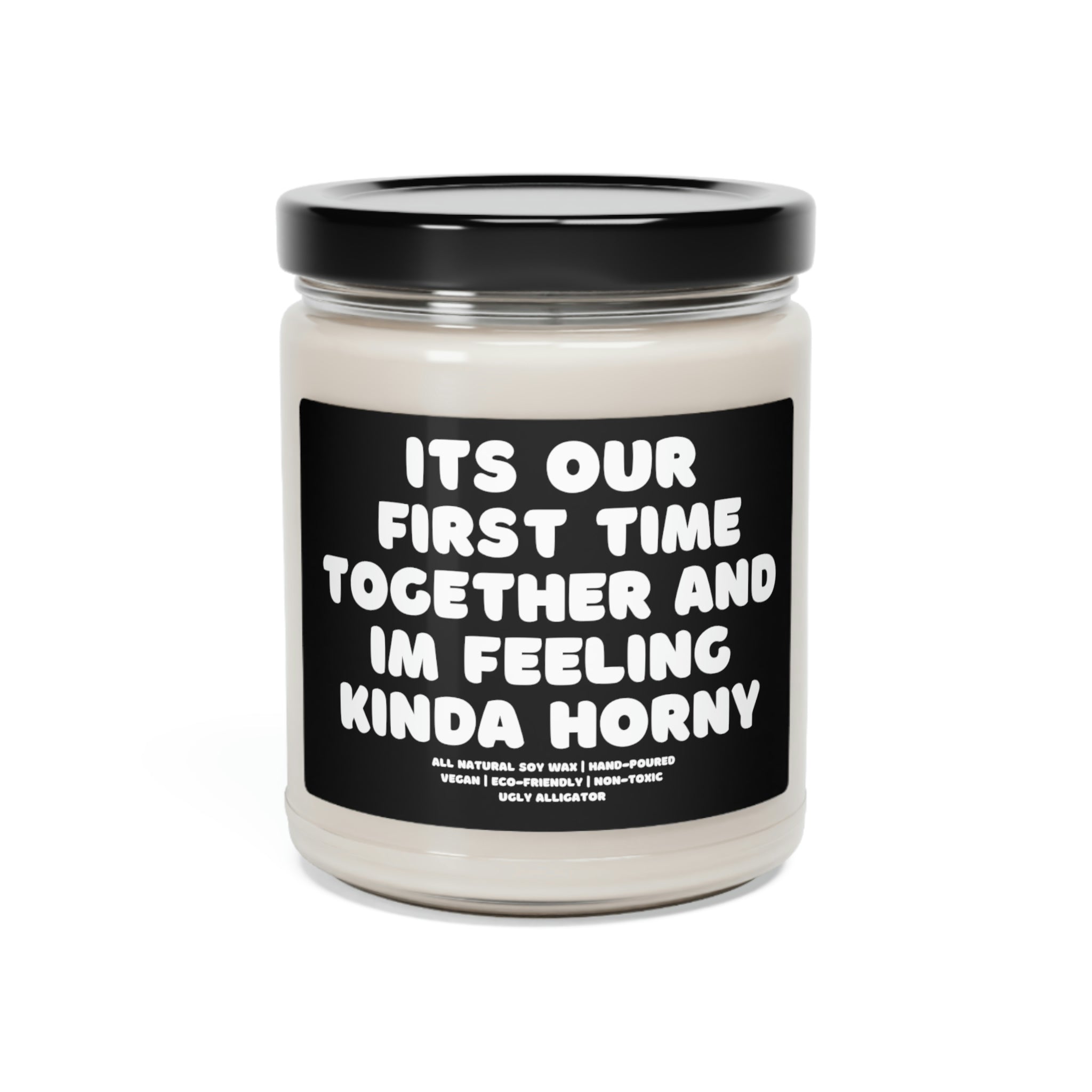 A stylish 9oz glass jar soy candle labeled 'It's Our First Time Together And I'm Feeling Kinda Horny', showcasing its elegant design and inviting aroma.