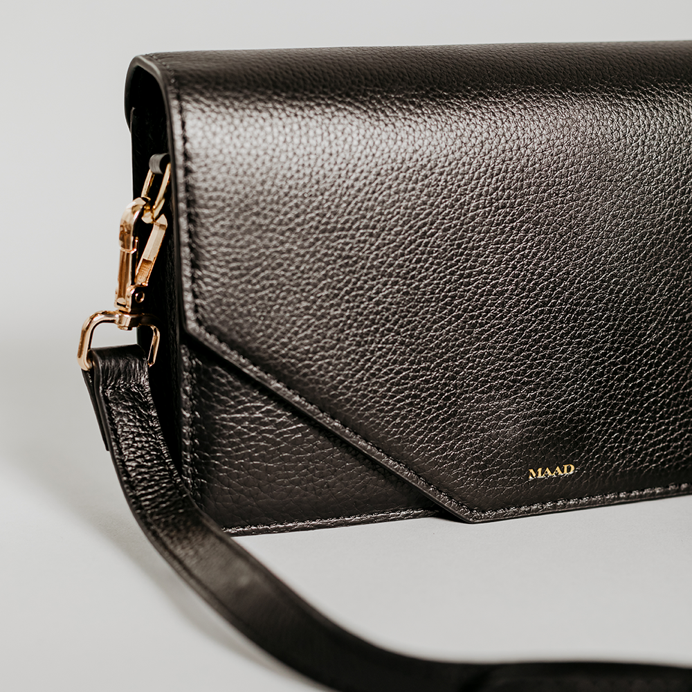 Match - Black Asymmetric Crossbody bag made of smooth pebble leather with an adjustable strap and interior cardholder.