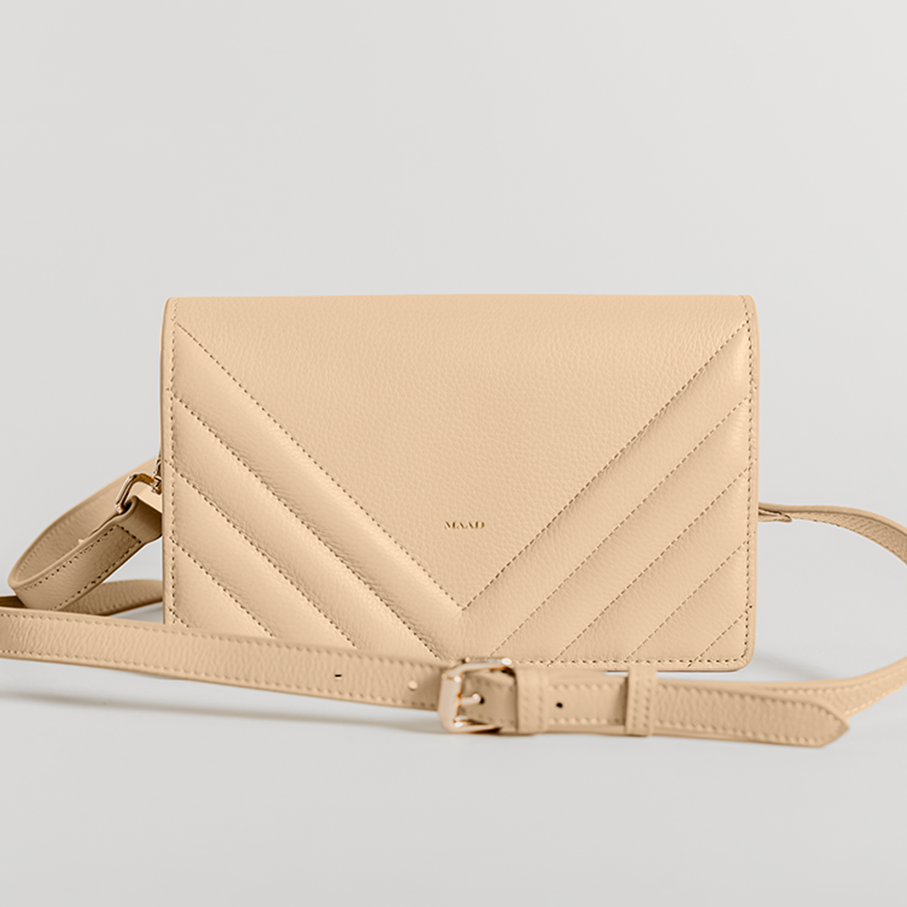 Match Sandy Nude Quilted Crossbody bag featuring smooth pebble leather, suede lining, and adjustable strap.