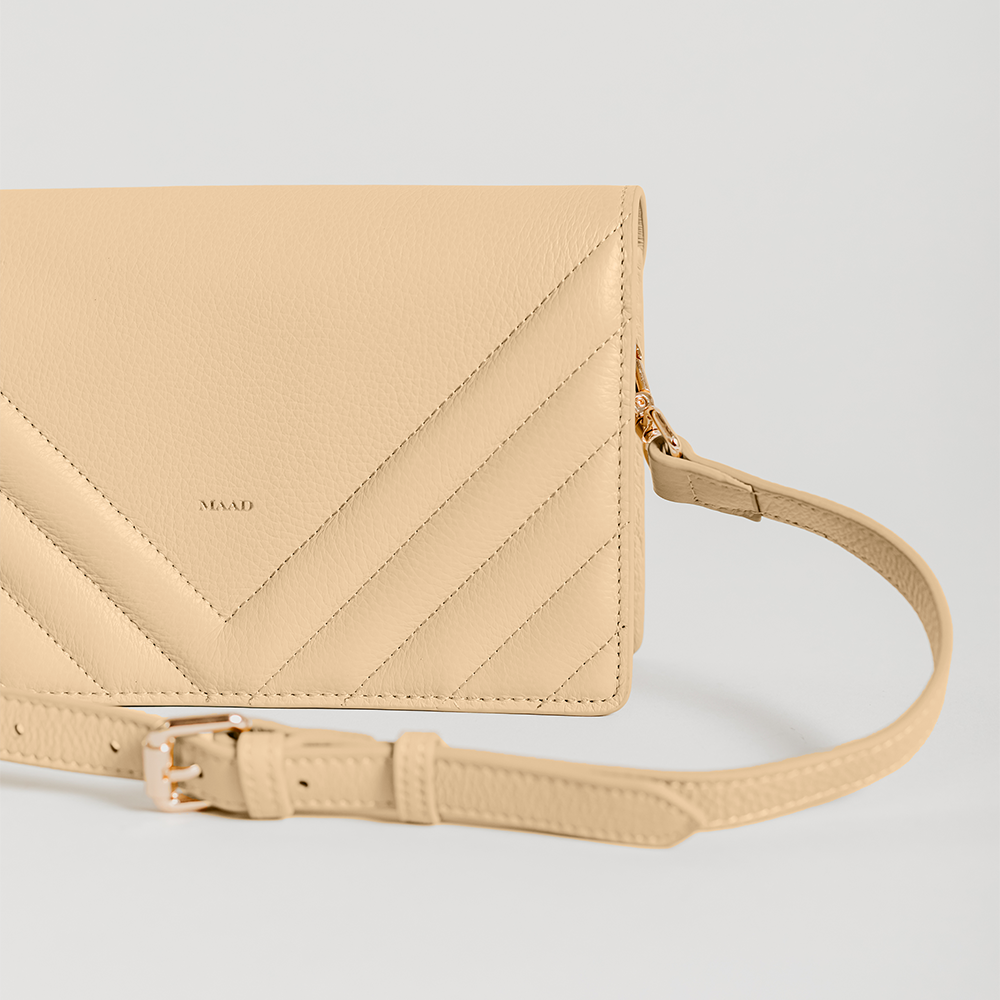 Match Sandy Nude Quilted Crossbody bag featuring smooth pebble leather, suede lining, and adjustable strap.