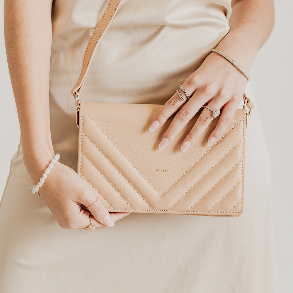 Match Sandy Nude Quilted Crossbody bag featuring smooth pebble leather, suede lining, and adjustable strap.