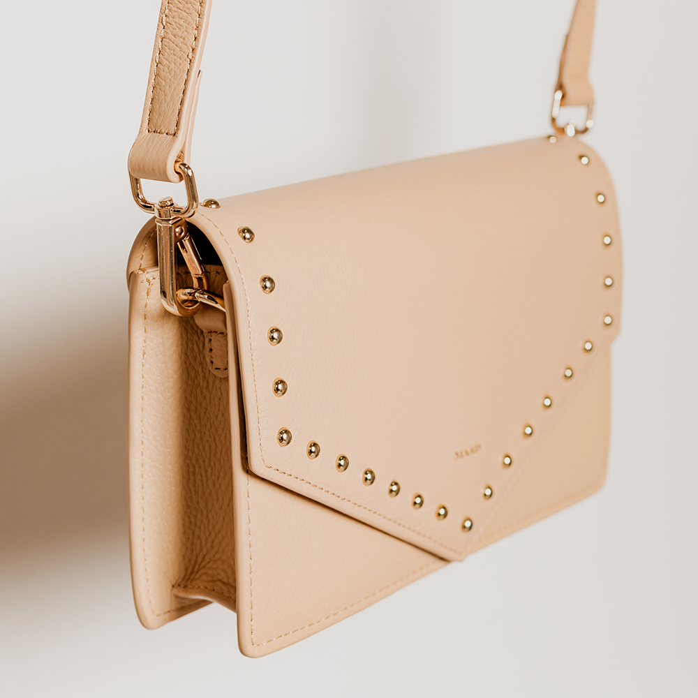 Match Sandy Nude Studs Crossbody bag featuring smooth pebble leather and adjustable strap.