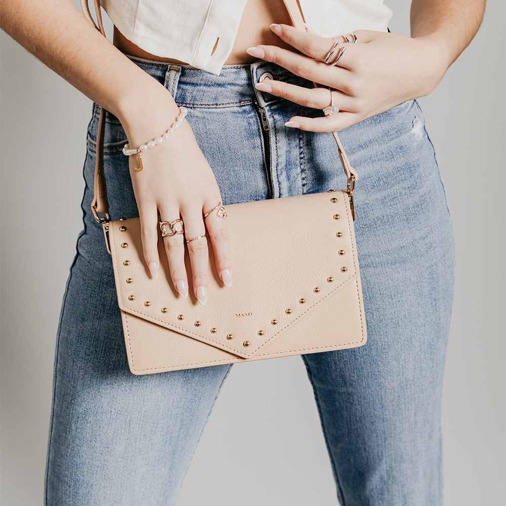 Match Sandy Nude Studs Crossbody bag featuring smooth pebble leather and adjustable strap.