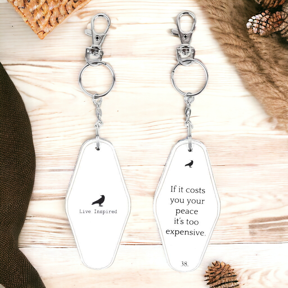 A collection of wooden key chains featuring various inspirational quotes, showcasing their durable design and stylish black and white colors.