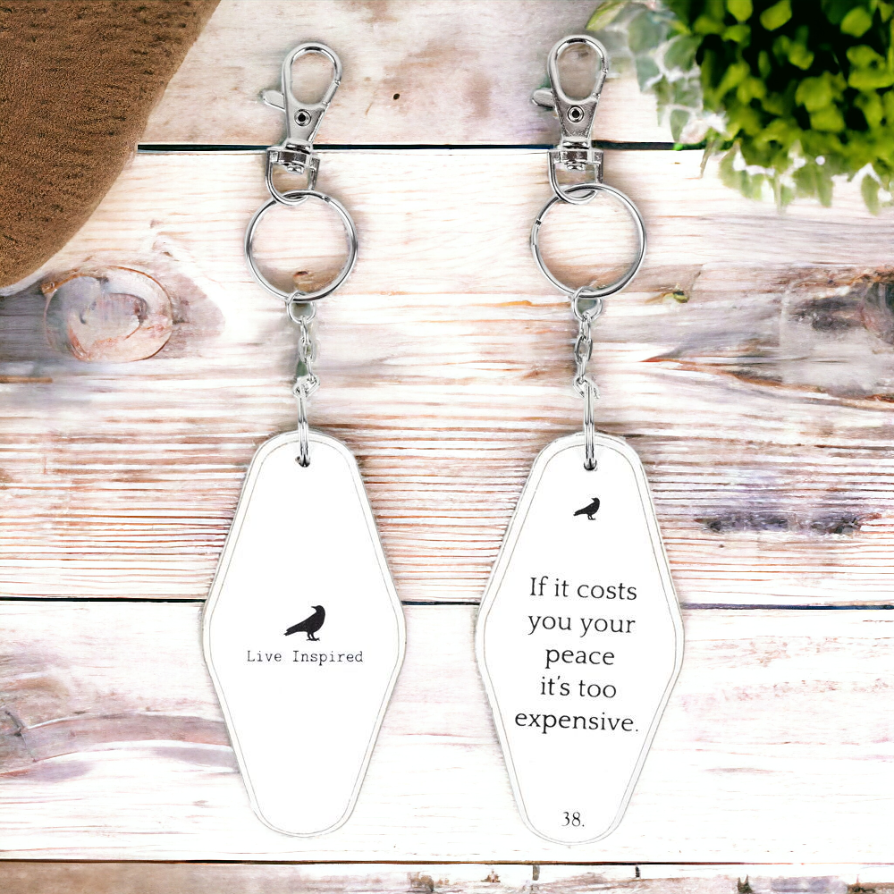 A collection of wooden key chains featuring various inspirational quotes, showcasing their durable design and stylish black and white colors.