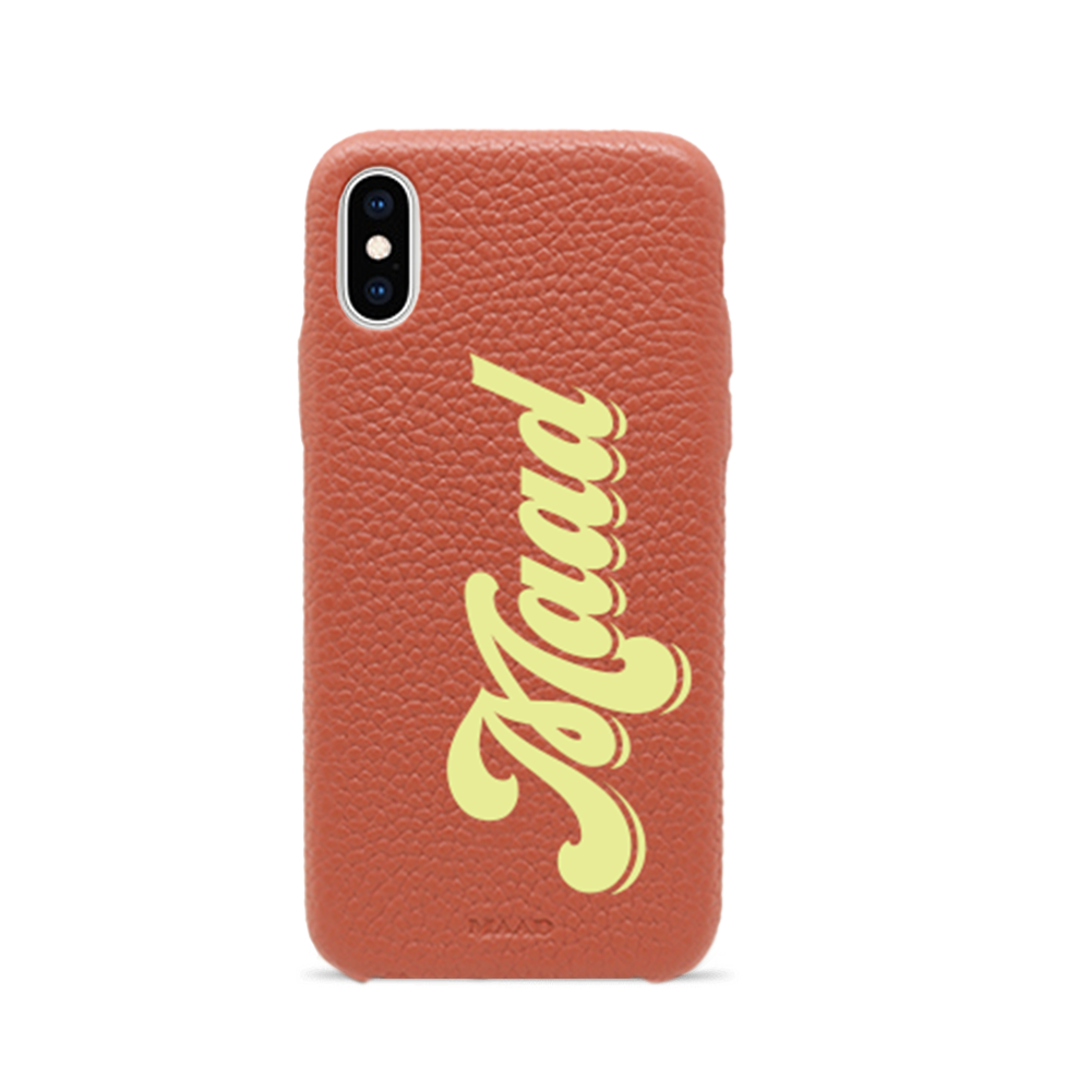 Terracotta pebble leather iPhone X/XS case with a minimalist design, showcasing personalization options and earthy tones.