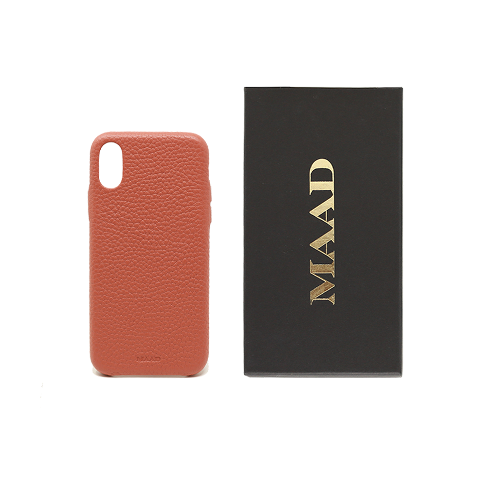 Terracotta pebble leather iPhone X/XS case with a minimalist design, showcasing personalization options and earthy tones.