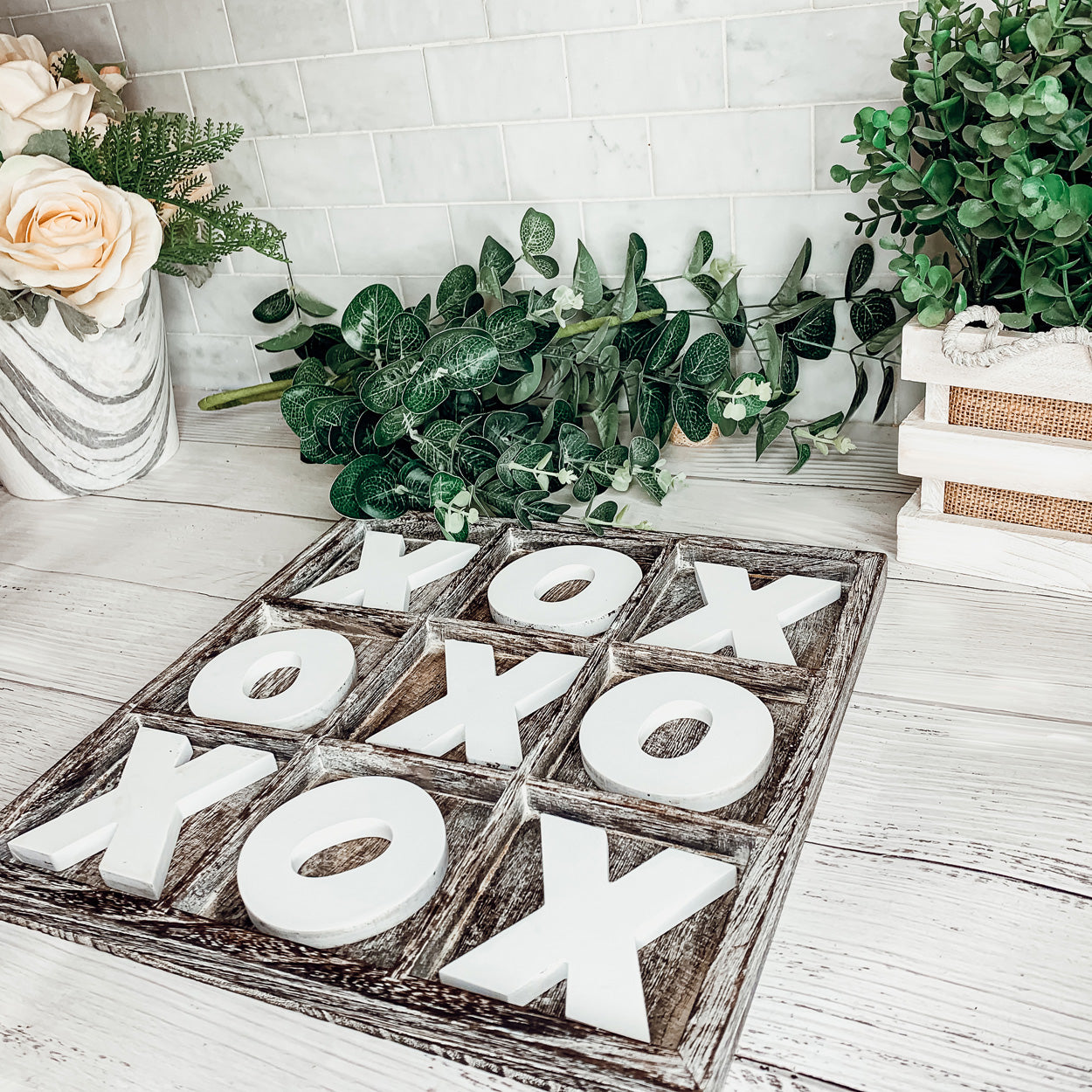 Rustic Tic Tac Toe game featuring a handmade wooden base with removable white and blackened game pieces, perfect for home decor and family fun.