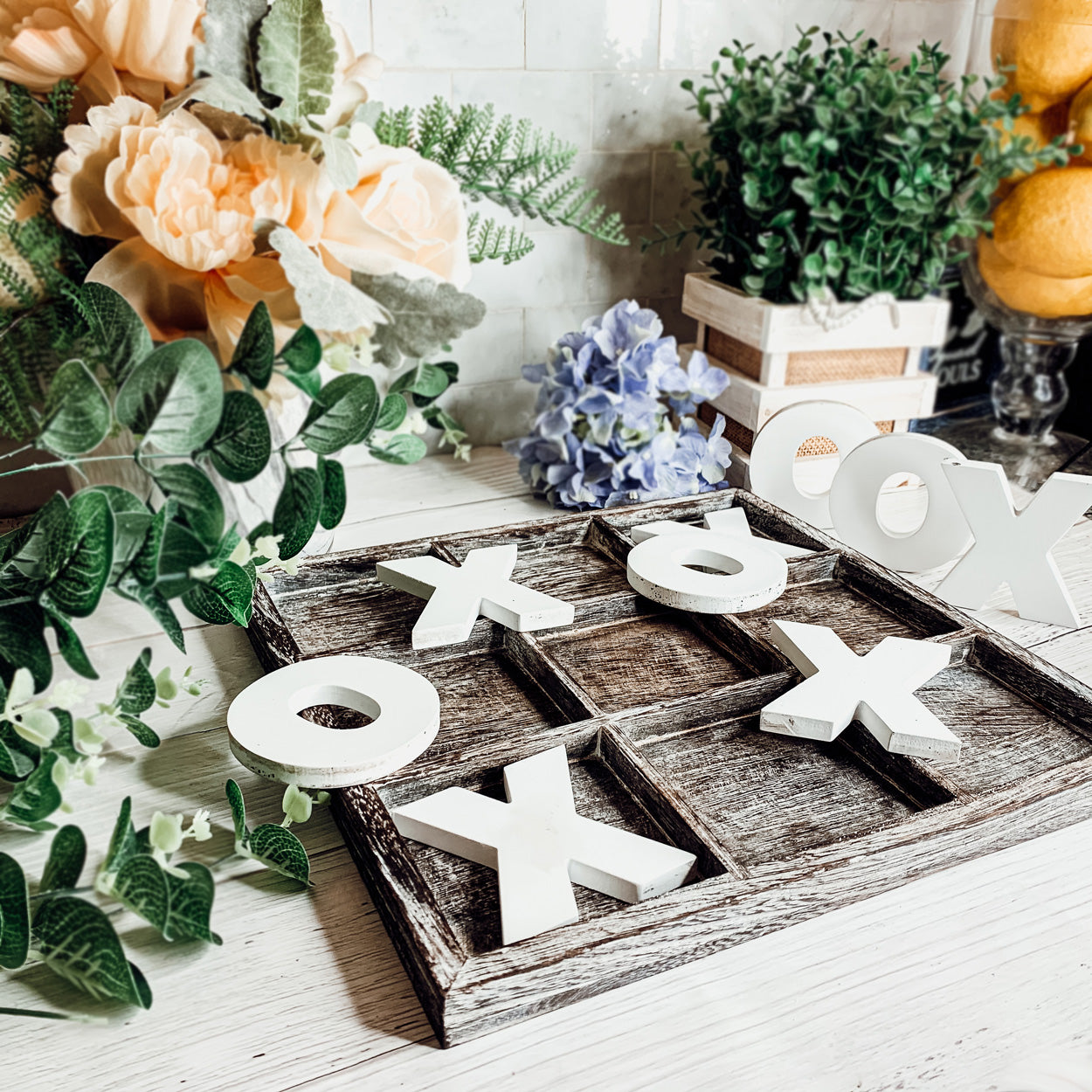 Rustic Tic Tac Toe game featuring a handmade wooden base with removable white and blackened game pieces, perfect for home decor and family fun.