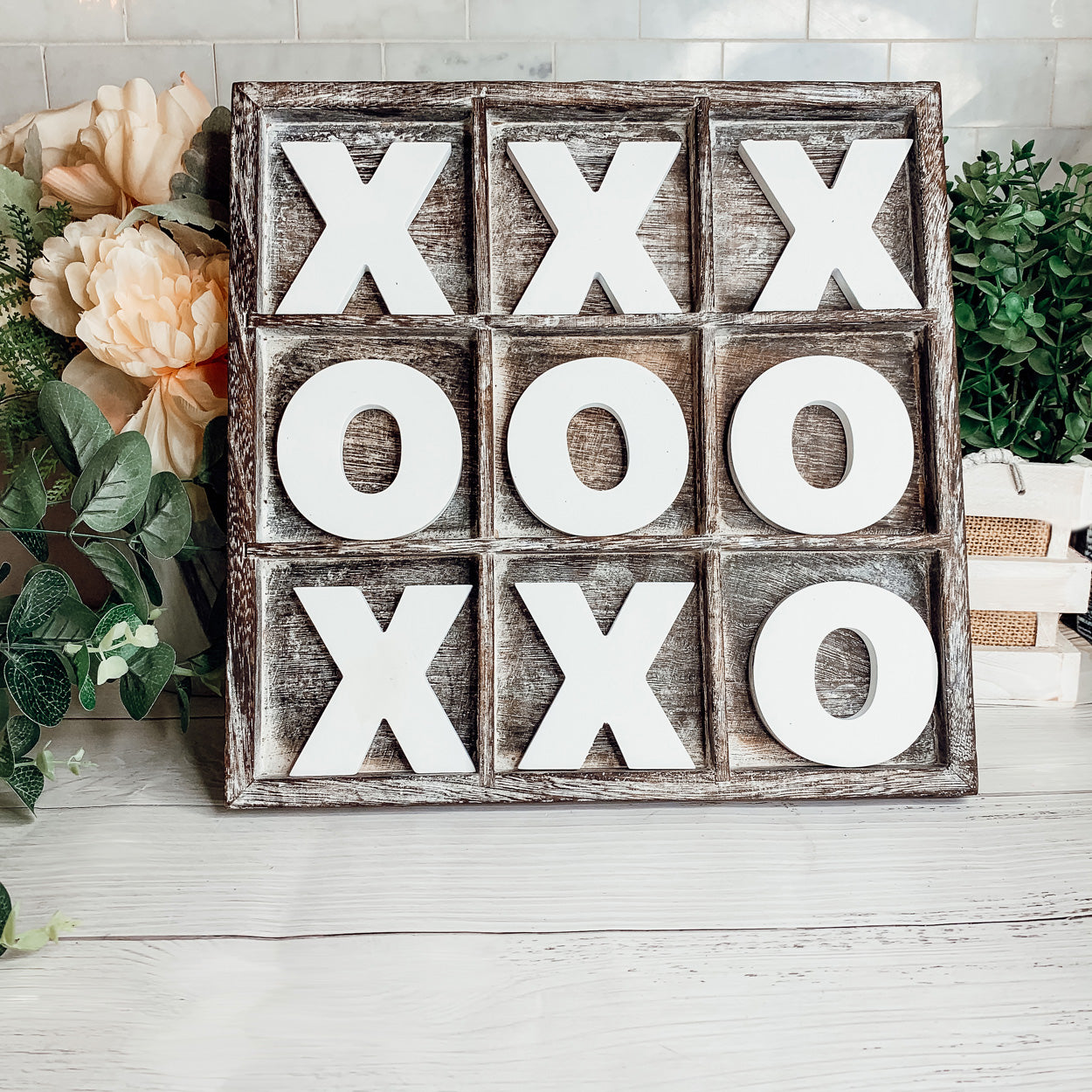 Rustic Tic Tac Toe game featuring a handmade wooden base with removable white and blackened game pieces, perfect for home decor and family fun.