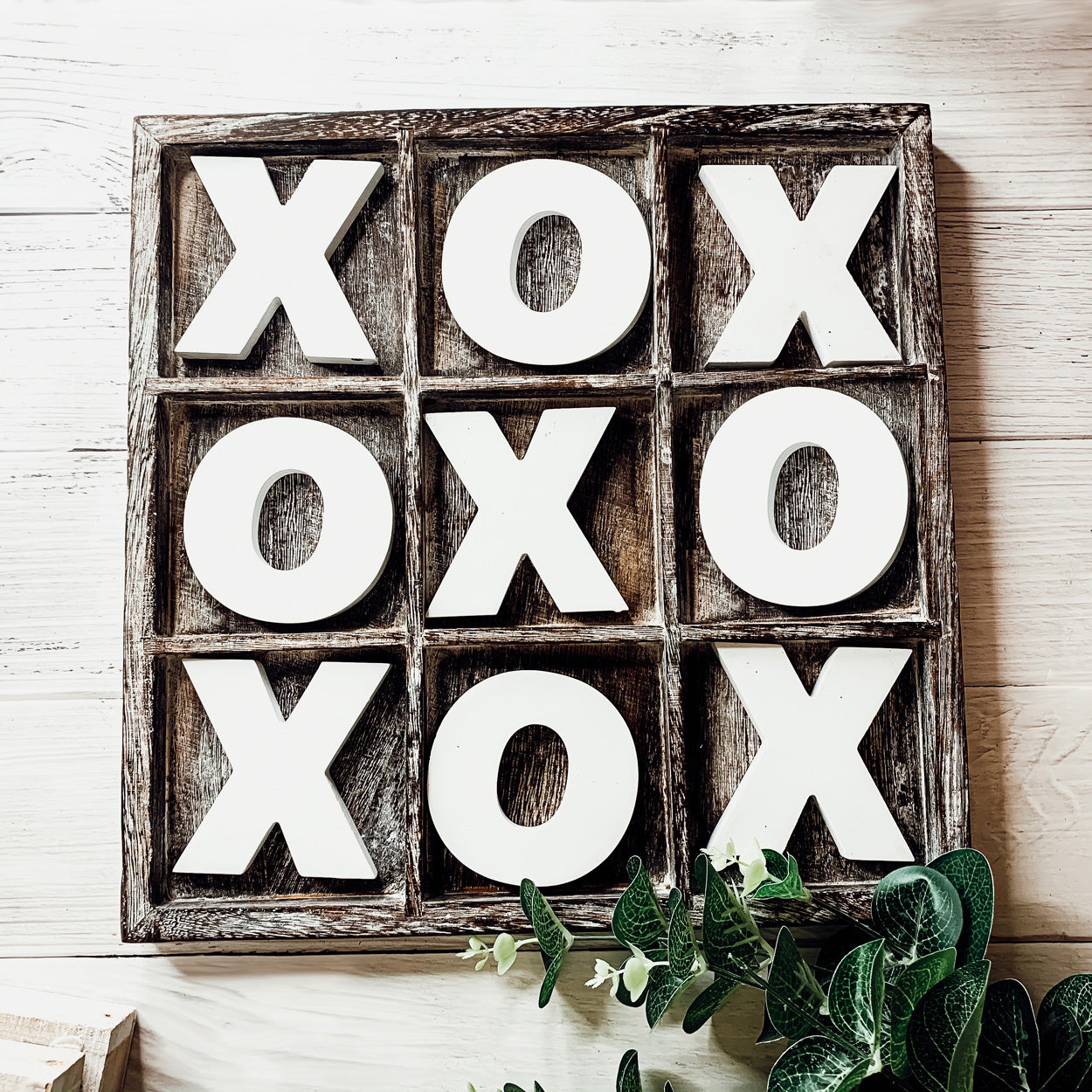 Rustic Tic Tac Toe game featuring a handmade wooden base with removable white and blackened game pieces, perfect for home decor and family fun.