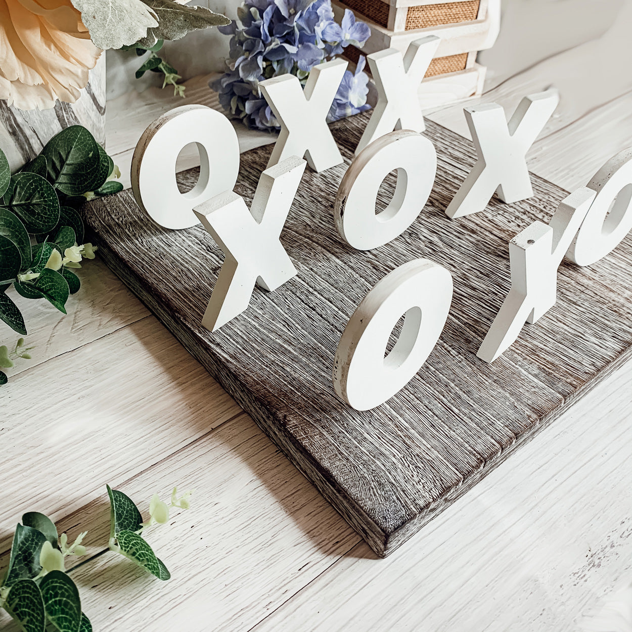 Rustic Tic Tac Toe game featuring a handmade wooden base with removable white and blackened game pieces, perfect for home decor and family fun.