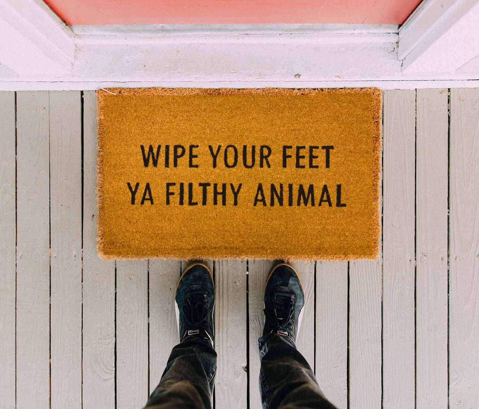 Wipe Your Feet doormat with humorous black script on natural coir background, perfect for outdoor use.