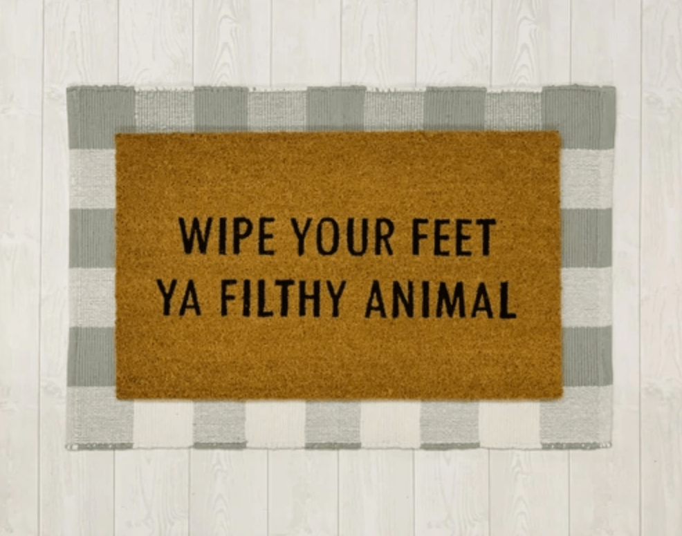 Wipe Your Feet doormat with humorous black script on natural coir background, perfect for outdoor use.