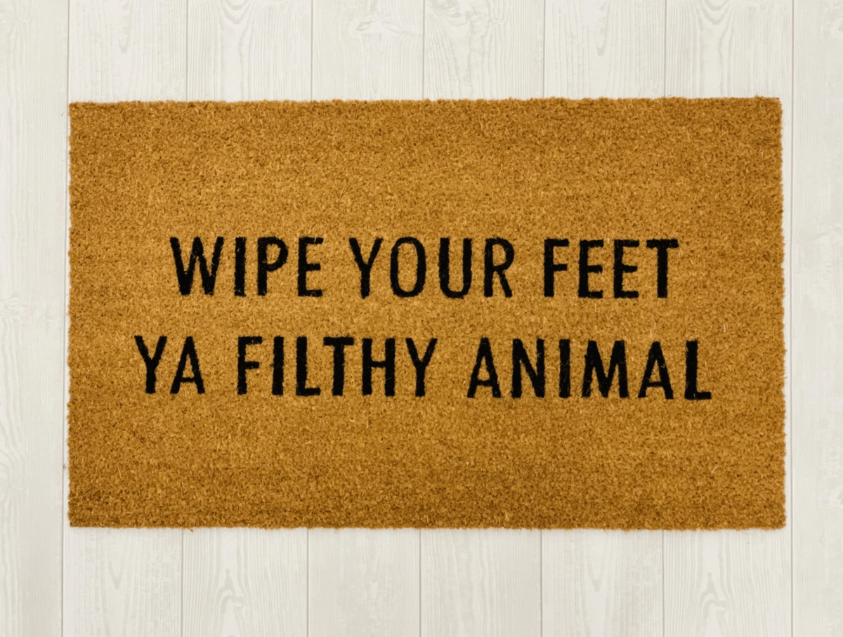 Wipe Your Feet doormat with humorous black script on natural coir background, perfect for outdoor use.