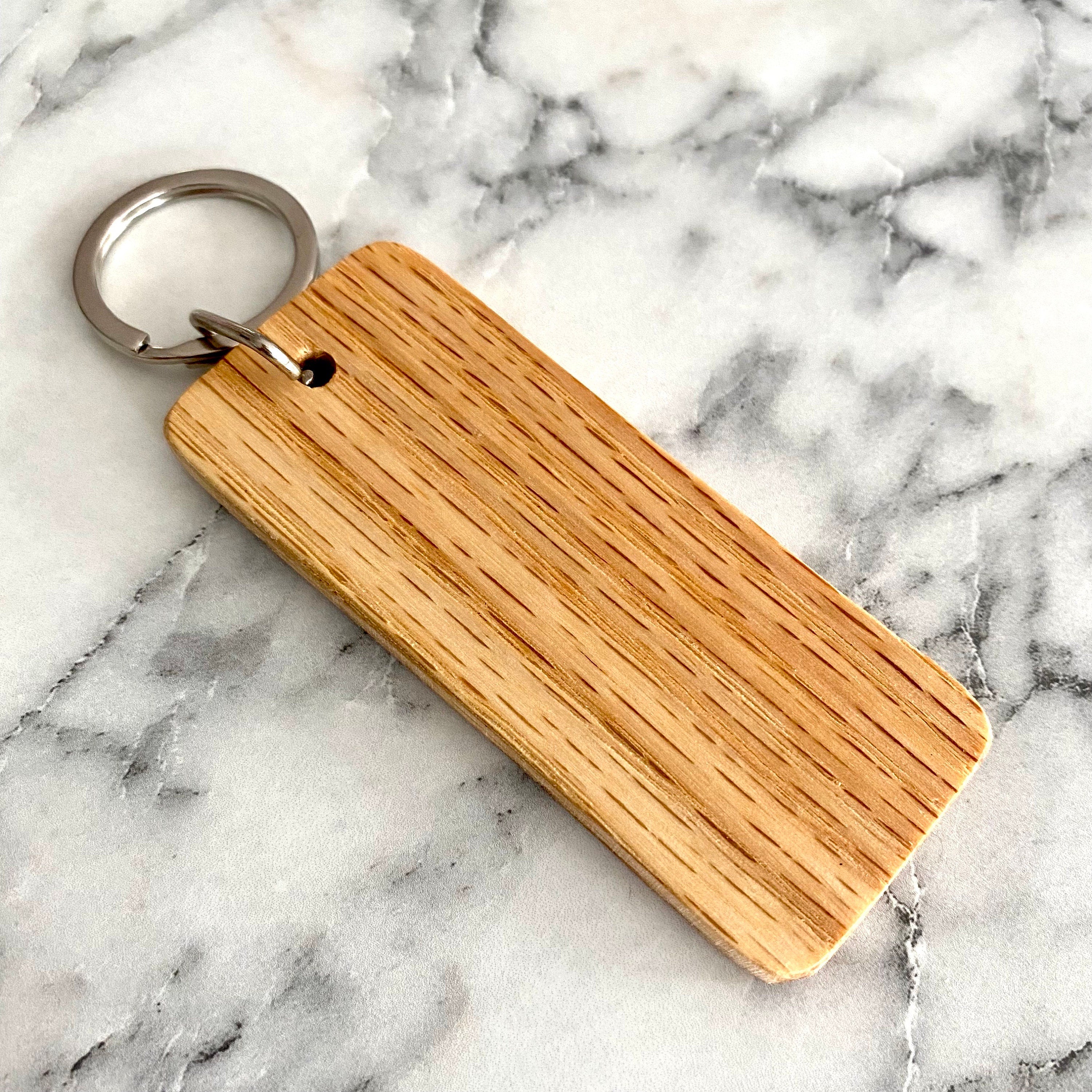 Engraved wood keychain featuring hearts and a custom date, perfect for 5-year anniversary gifts.