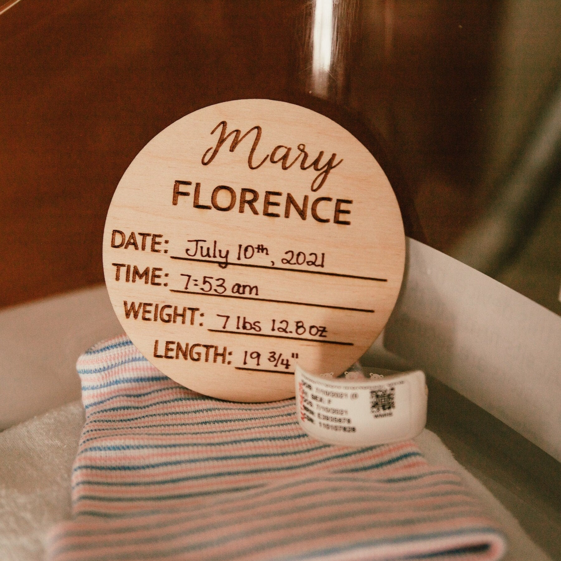 A beautifully crafted birch wood milestone card for documenting baby's birth stats, featuring laser engraving and a smooth finish.