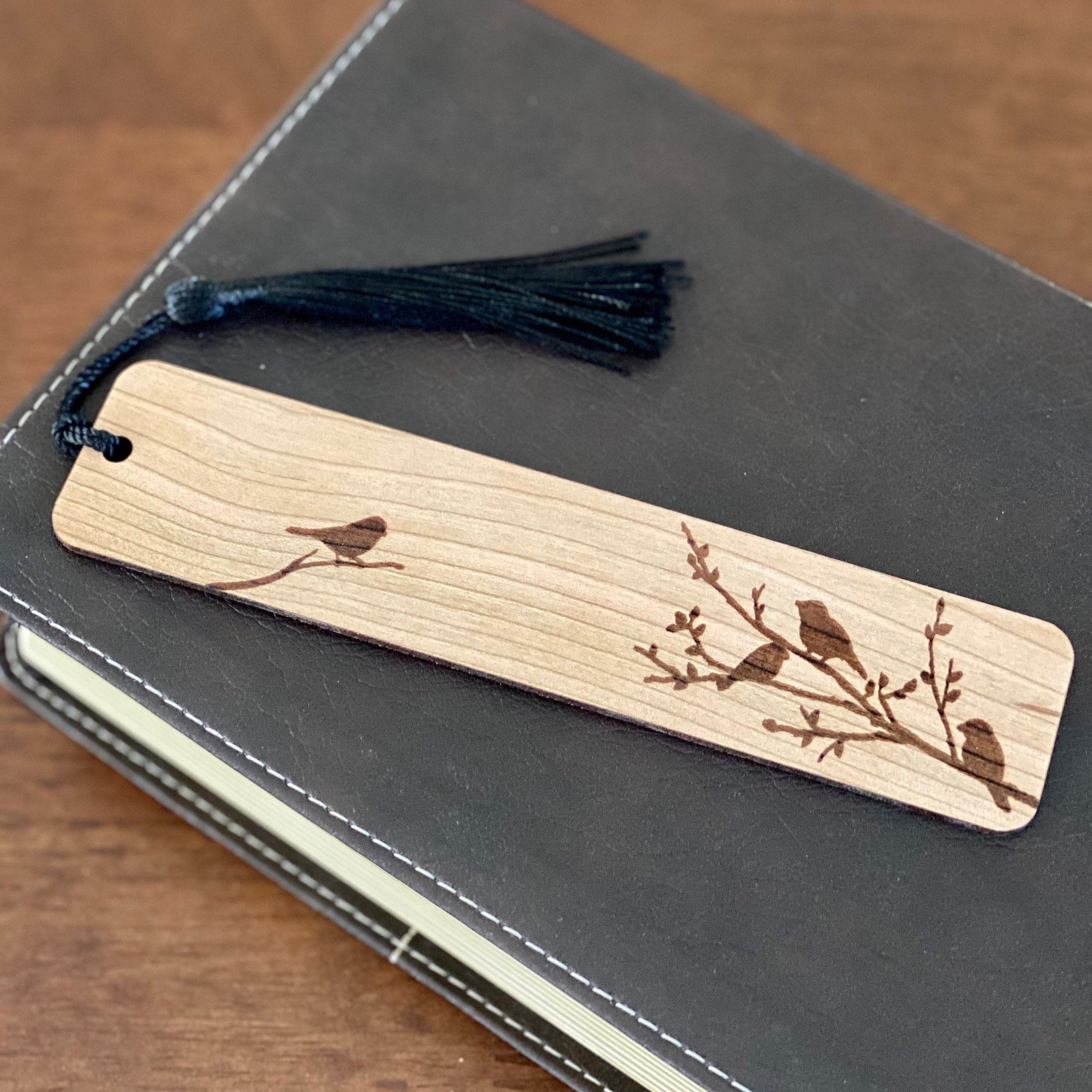 Engraved wood bookmark featuring silhouettes of birds on branches, made from Cherry hardwood with a colorful tassel.