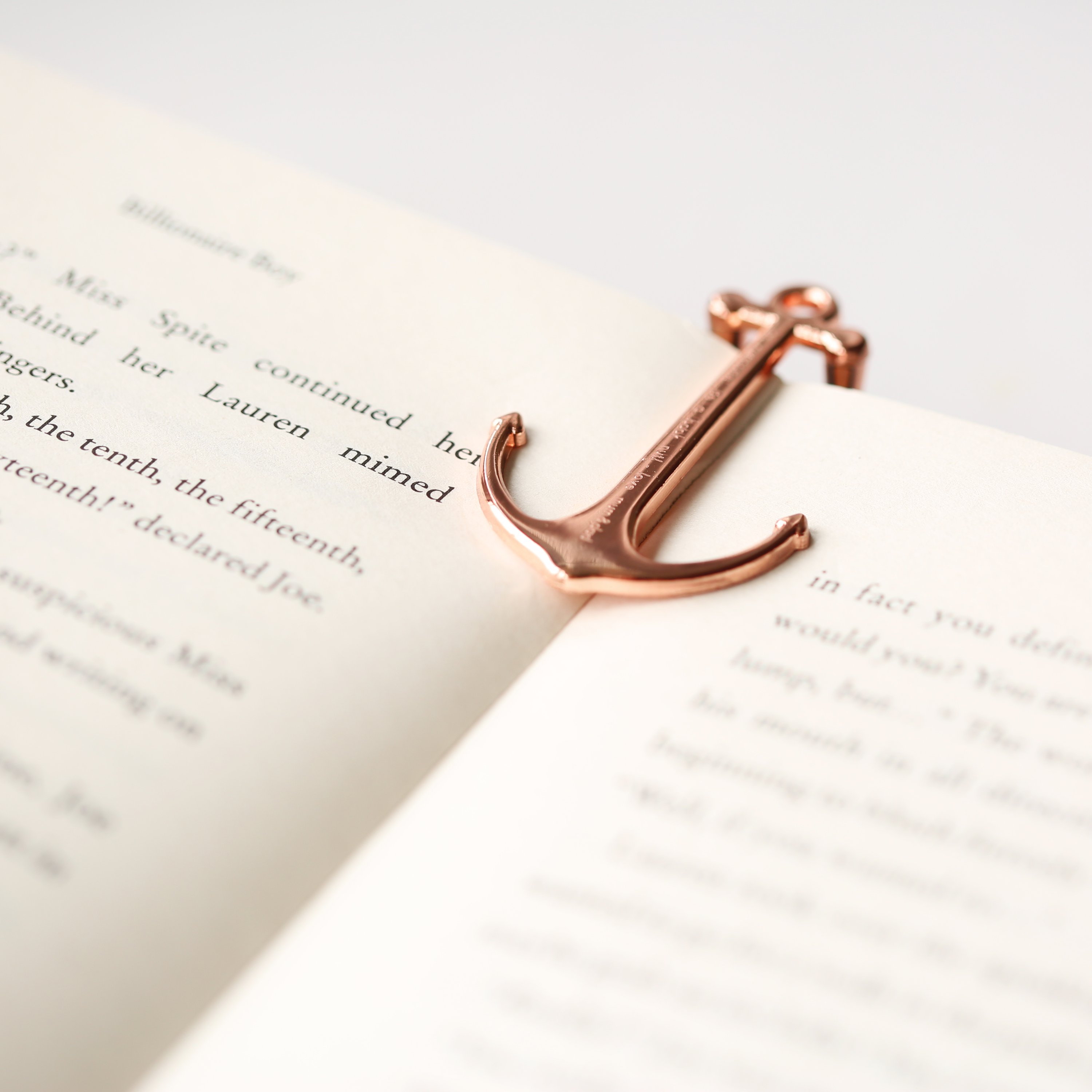 Gold and Rose Gold Book Anchor, elegantly designed to hold books open, featuring personalized engraving options.