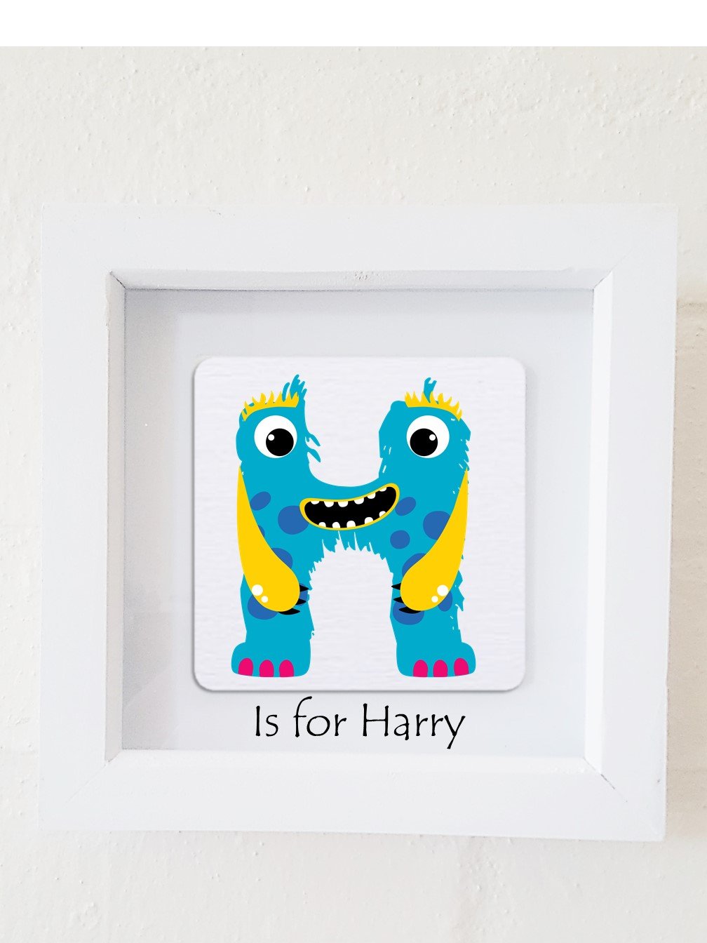 A colorful framed plaque featuring a monster design, personalized with a child's initial and name, perfect for children's bedroom decor.