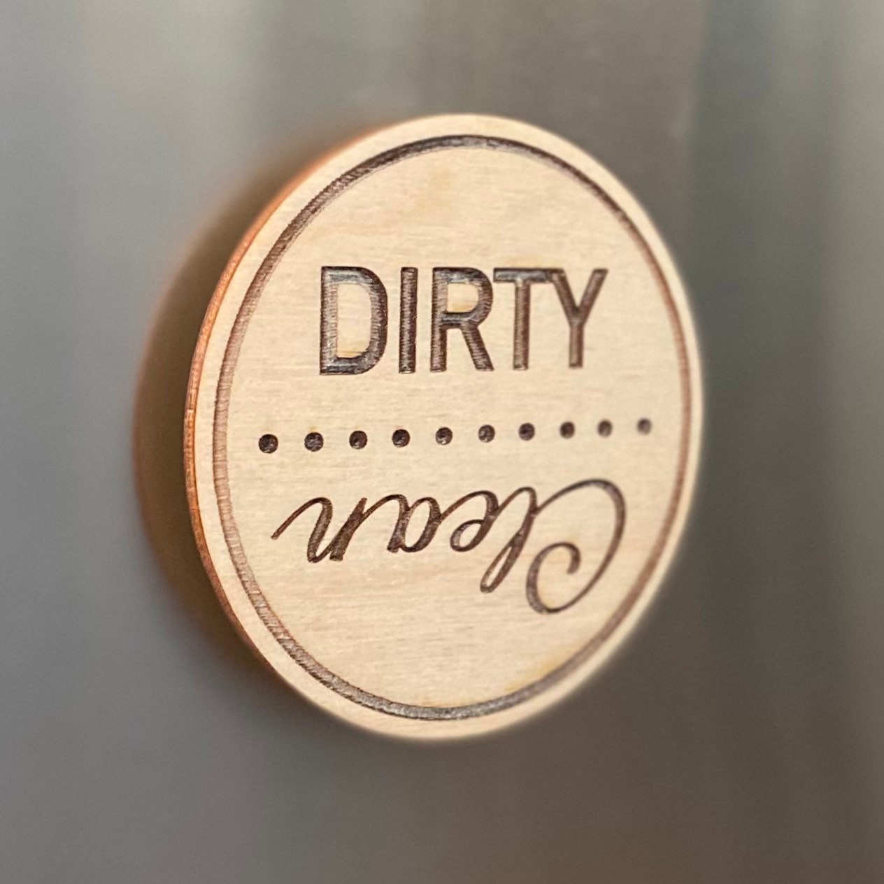 Engraved wood disc magnet for dishwasher status, featuring clean and dirty indicators.