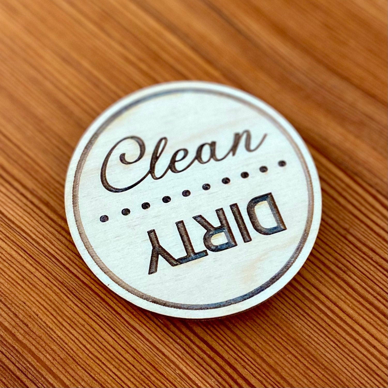 Engraved wood disc magnet for dishwasher status, featuring clean and dirty indicators.