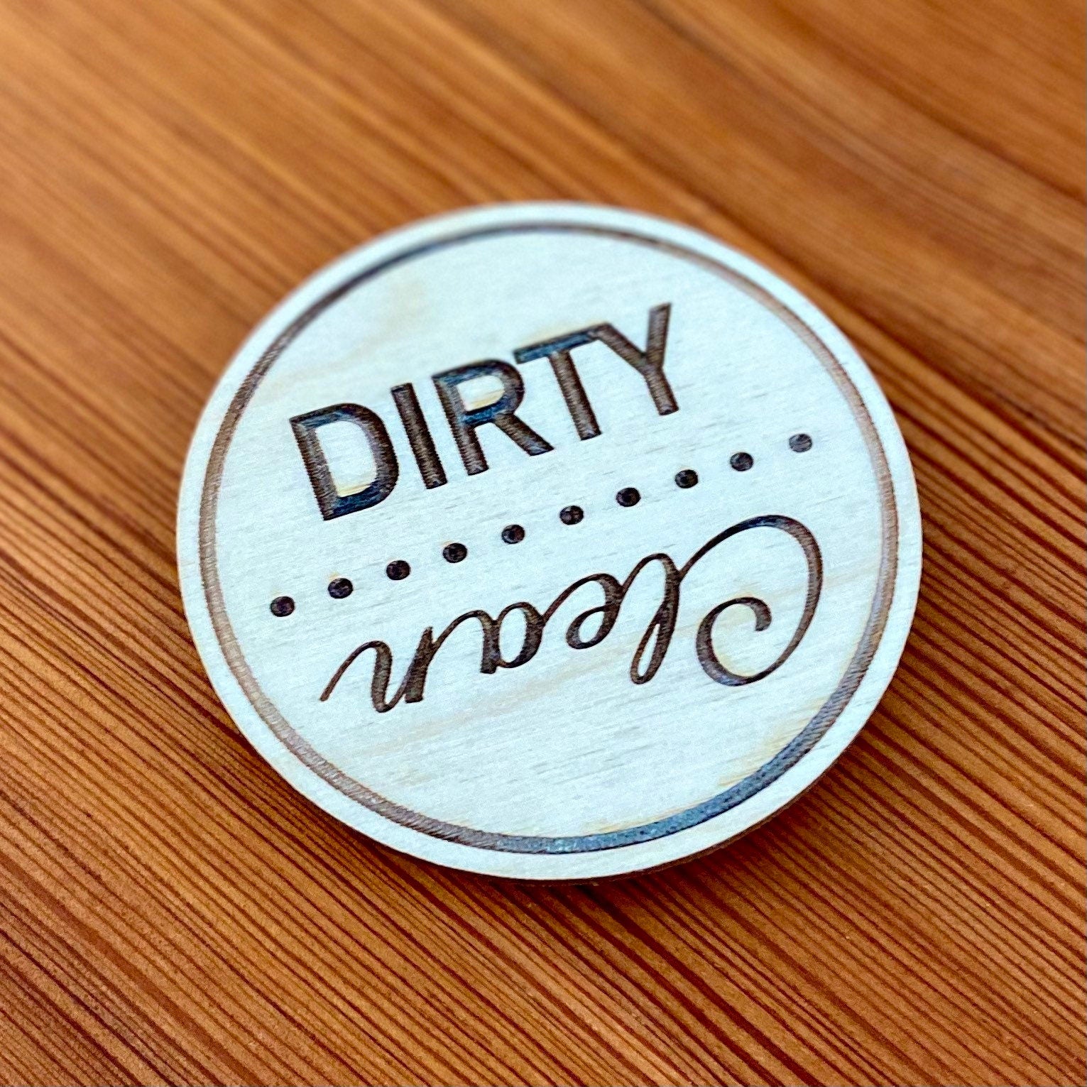 Engraved wood disc magnet for dishwasher status, featuring clean and dirty indicators.