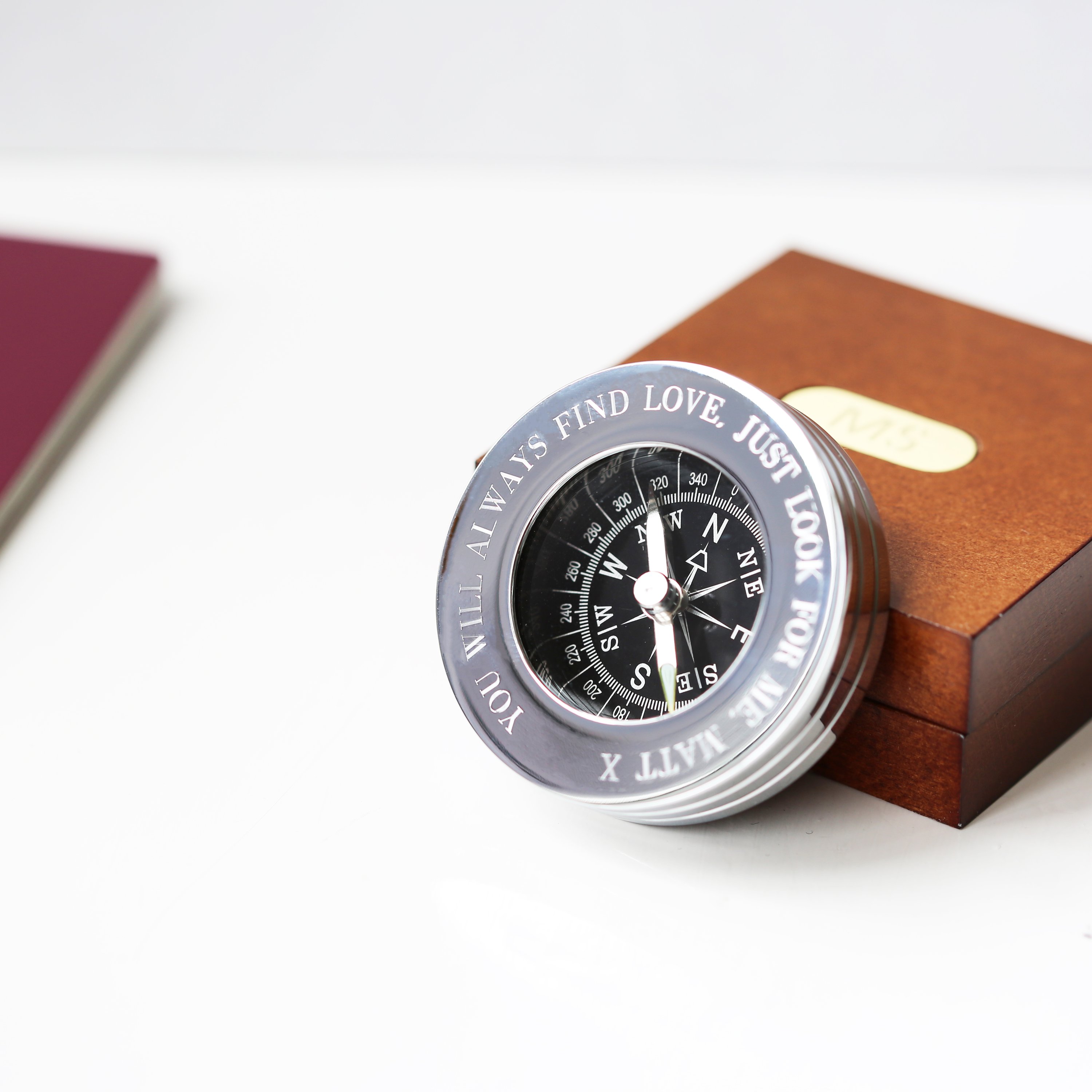 Personalised brass compass displayed in a fine mahogany timber box, showcasing its elegant design and engraving.